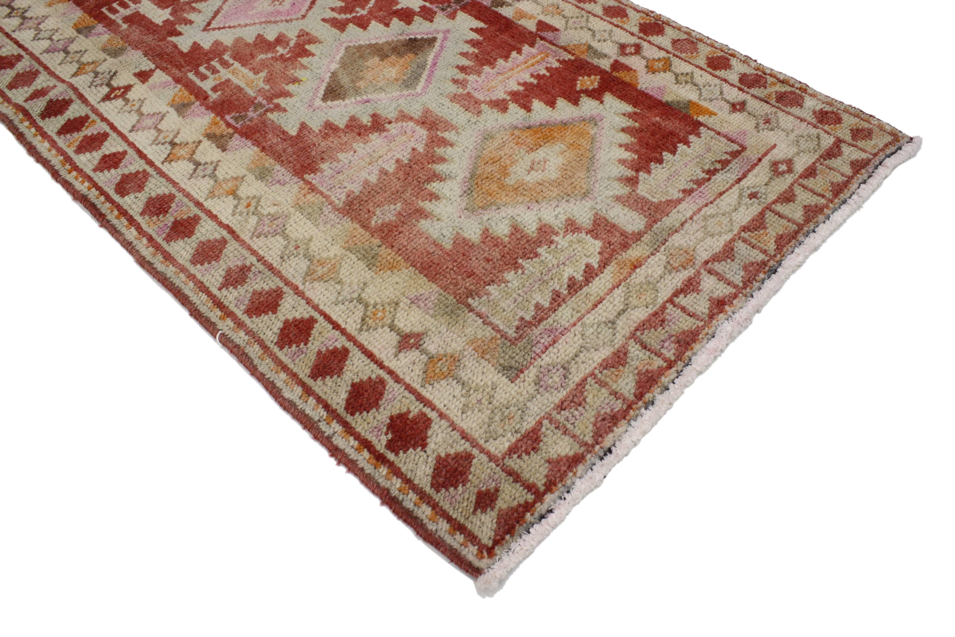 Create a comfortable and tasteful setting with this vintage Turkish Oushak carpet runner. With its narrow size, this vintage Oushak runner is perfect for stairs, skinny hallways, narrow foyers, entryways and galley kitchens. Featuring a refined