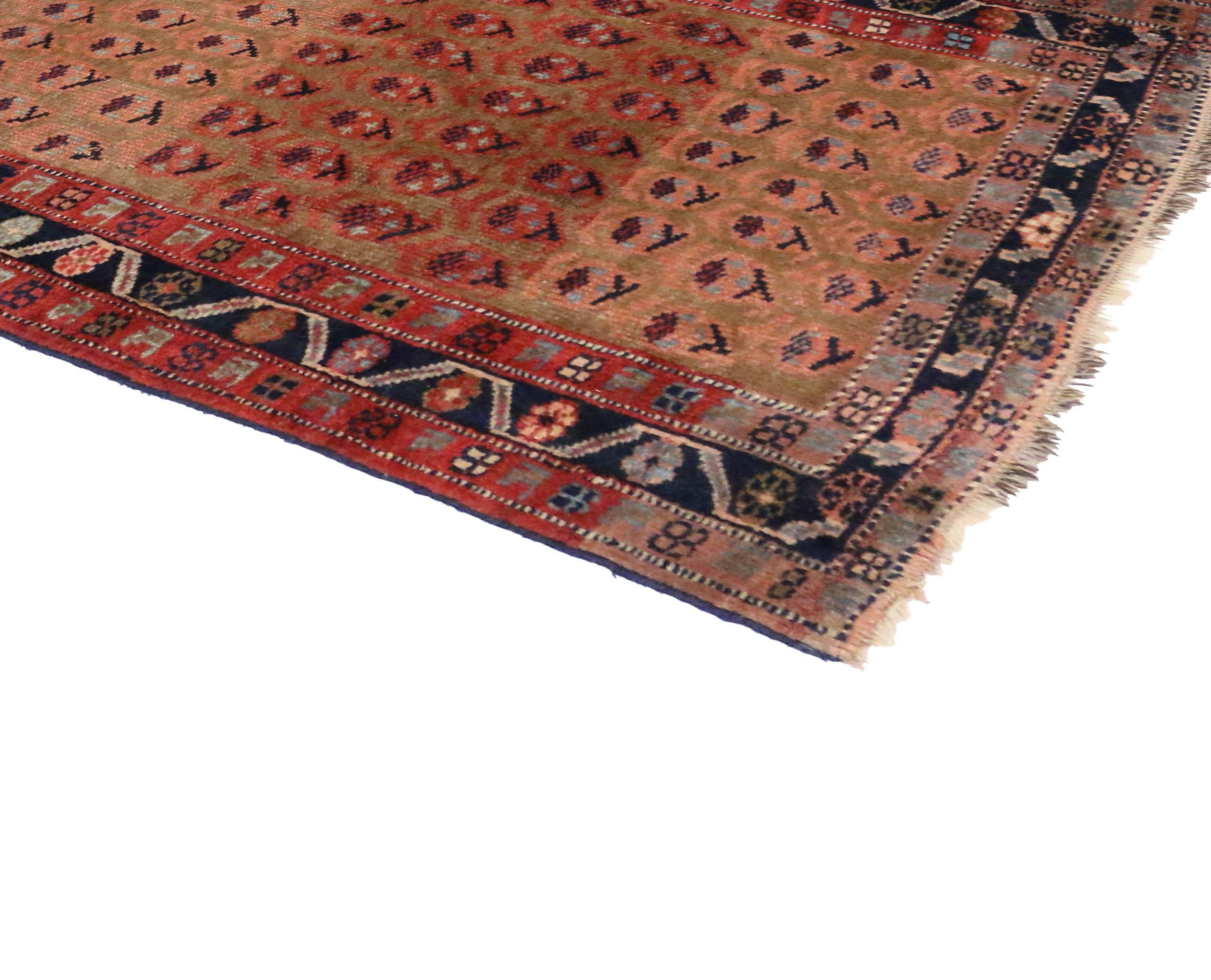 Delicate yet bold, this extravagant antique Persian Kurd carpet runner displays an all-over repetitive pattern of opulent boteh motifs. The boteh resembles sprouting seed and is known as the “Seed of Life.” It represents potential for growth and