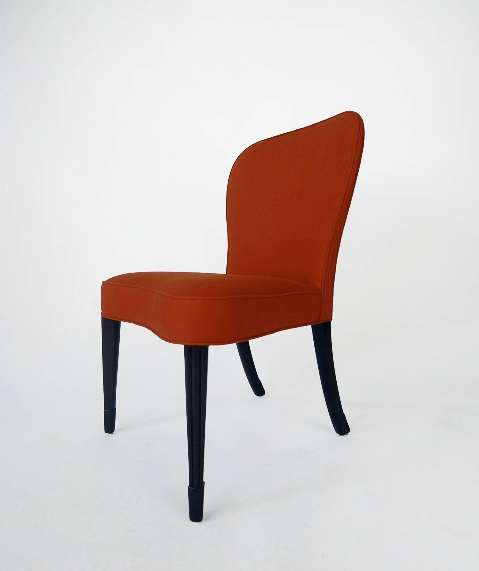 Chair designed by Edward Wormley, for Dunbar, circa 1956. Newly reupholstered in a saffron red linen. Brand new strapping, foam and fabric. A beautifully designed chair with fluted front legs.