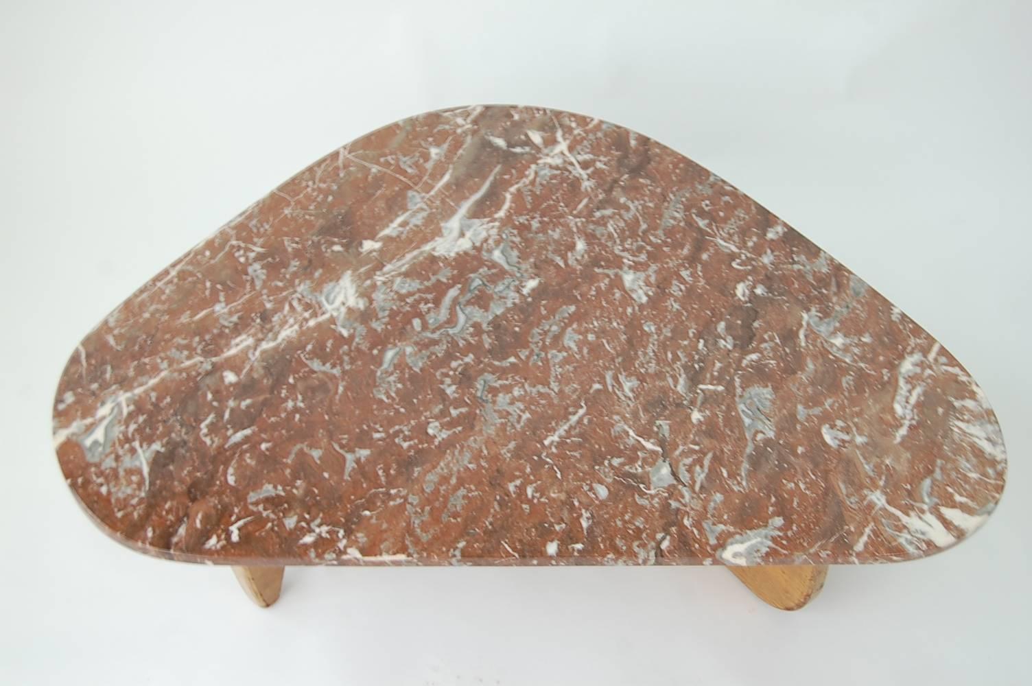 Isamu Noguchi Style coffee table with spectacular Rojo Alicante marble top and oak base. Base shows typical wear for a piece of its age, which we would estimate to be mid-1950s. We can have the base refinished for an additional $300.00, if the