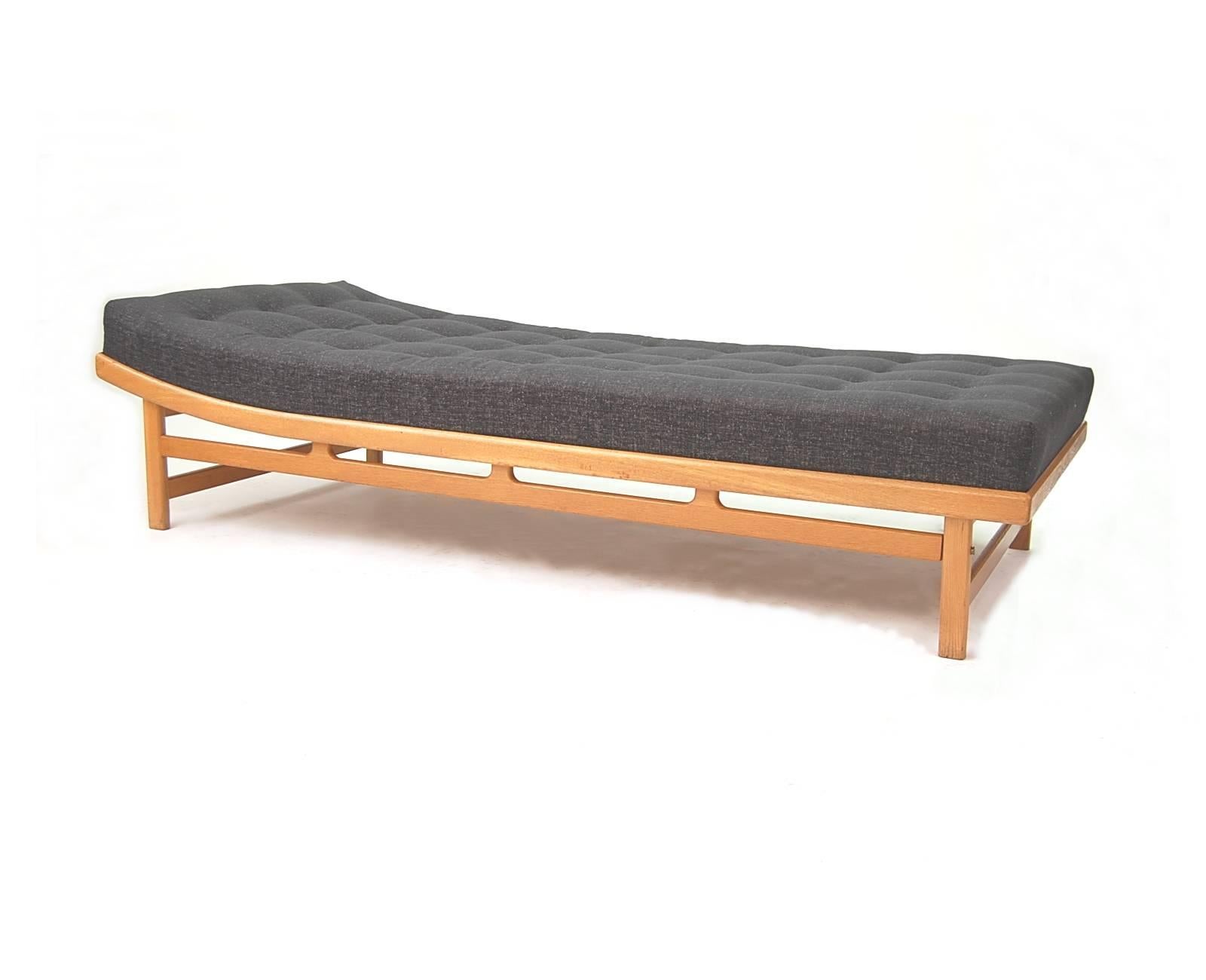 Danish modern daybed in oak, attributed to Børge Mogensen. The mattress has internal springs, much like a traditional mattress, so it provides exceptional support. Newly upholstered in a charcoal grey rayon poly mix (78.68 rayon . 21.32 poly .