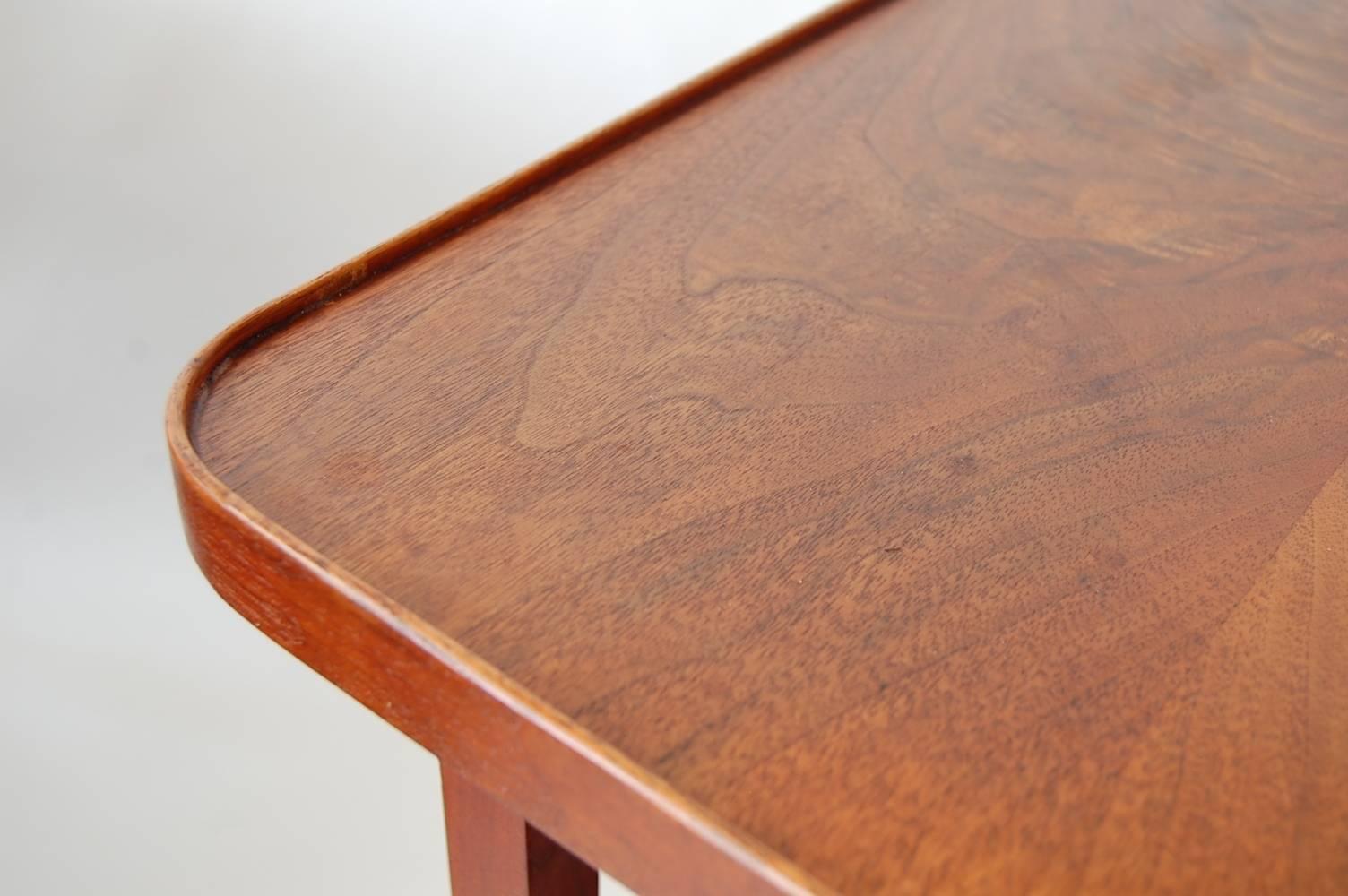 Pair of large scale end tables in walnut, designed by Milo Baughman for Arch Gorgon. Each having a lower shelf, two lower drawers, and nicely figured book matched crotch walnut tops with rounded corners, and a small gallery around the edge.