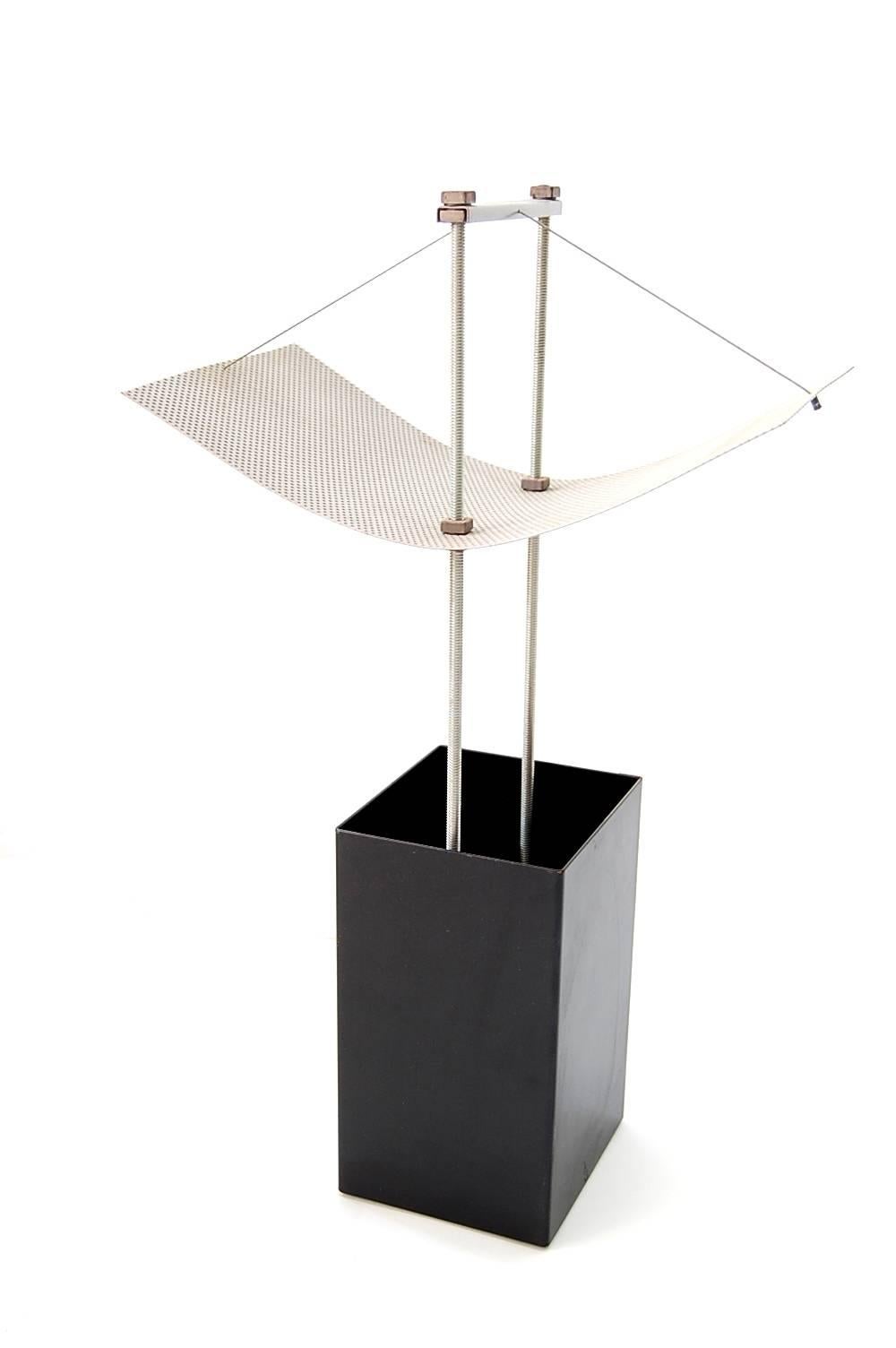 Table lamp, circa 1982, American. We're unsure who designed this lamp, but feel that it must have been designed by an Architect due to the form, and choices of materials. The black body contains the bulb, that when lit, shines upwards at the