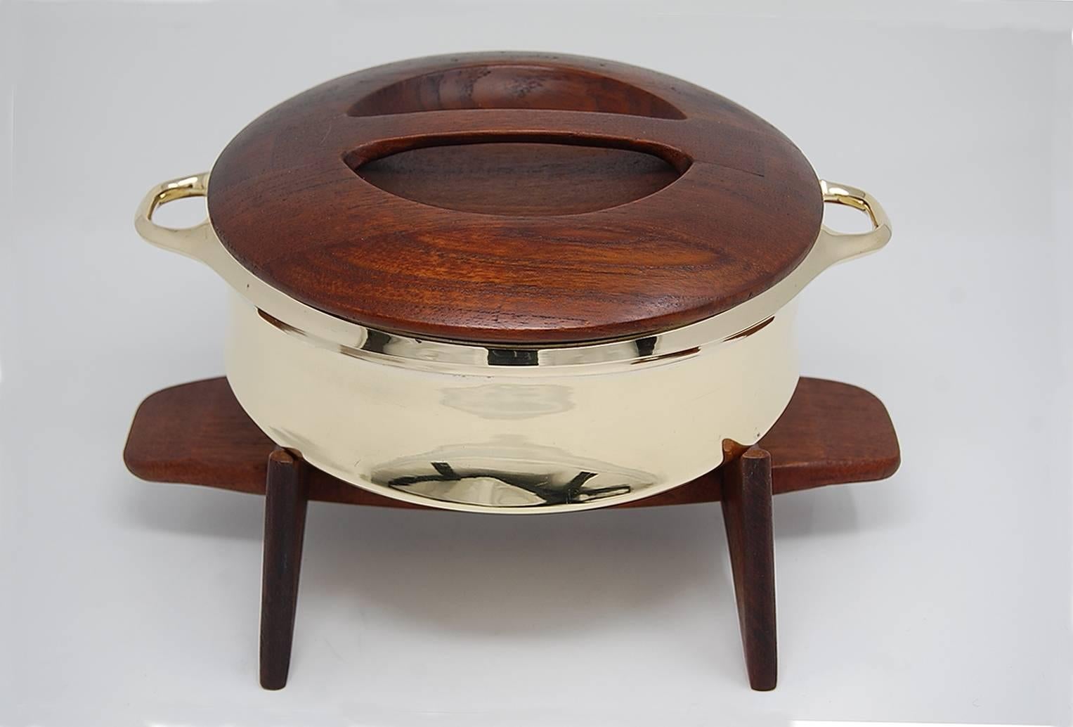 Fondue pot designed by Jens Quistgaard for Dansk of Denmark, circa 1955. Solid brass pot, with staved teak top, and solid teak base. Fully signed with early Dansk marks. The craftsmanship on this piece is outstanding. Newly polished brass, and