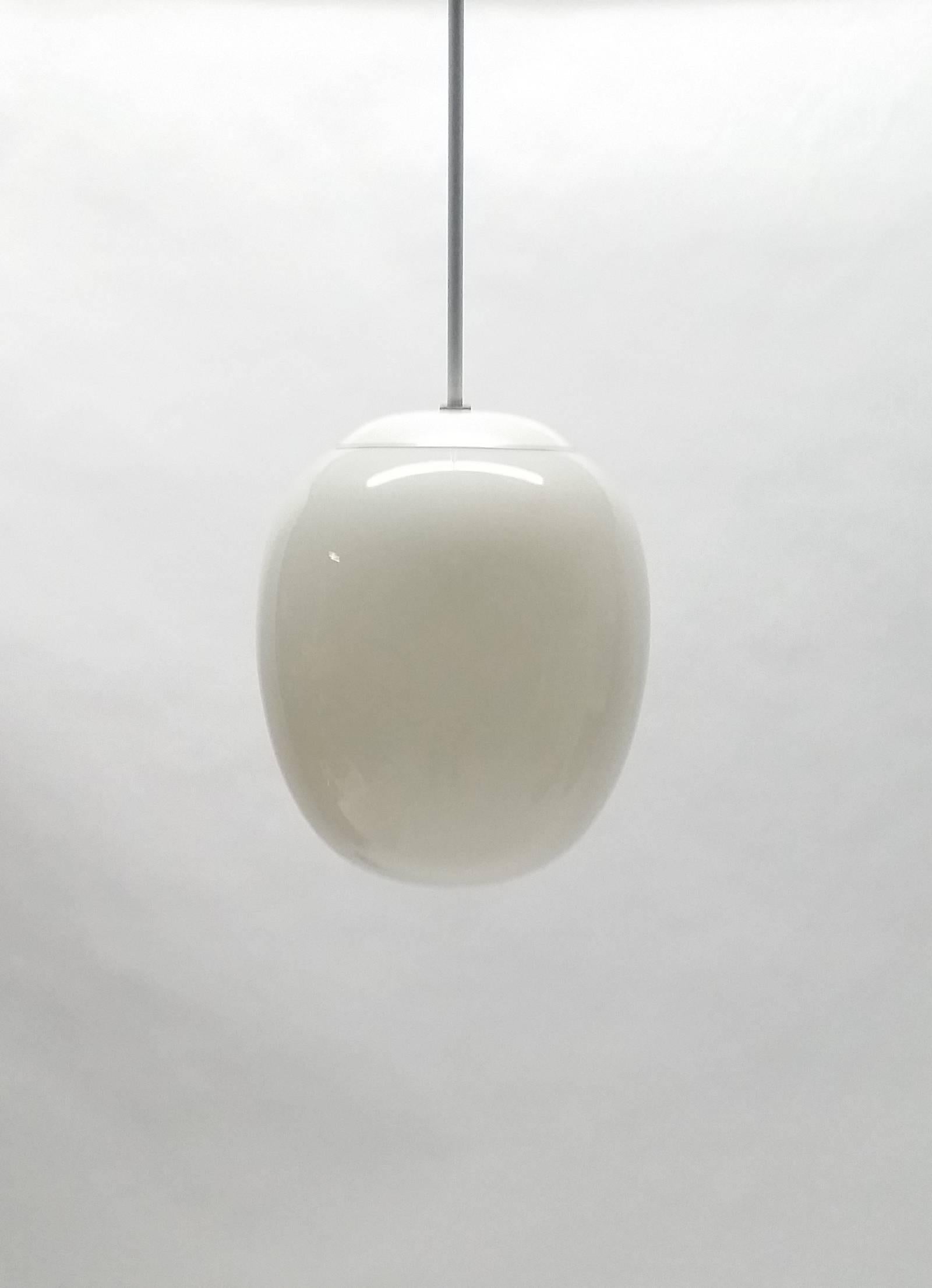 Vintage pendant light with egg shaped glass shade. The form is also very similar to Piet Hien's super egg or super-elipse. Fixture itself measures 12" tall x 9.5" wide. Drop is currently 20 inches, but we can have that changed to any spec