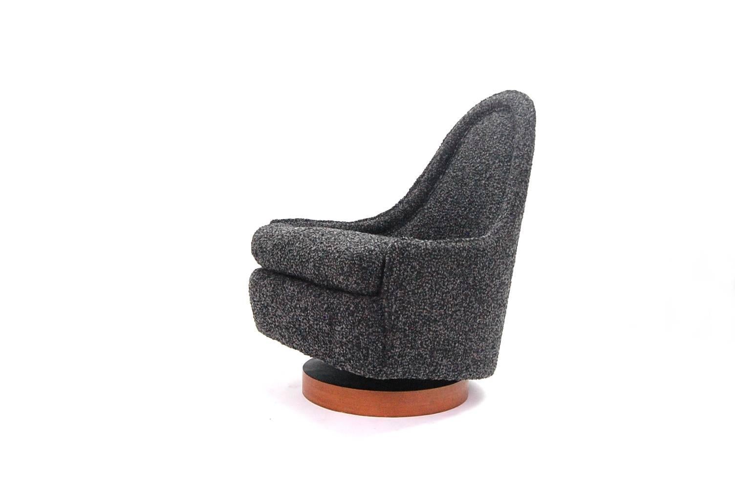 Petite chair designed by Milo Baughman for Thayer Coggin, circa 1966. Chair sits on a circular walnut veneer base, and swivels. It also has a spring mechanism, so it rocks as well. Professionally reupholstered in a black and grey wool cashmere woven
