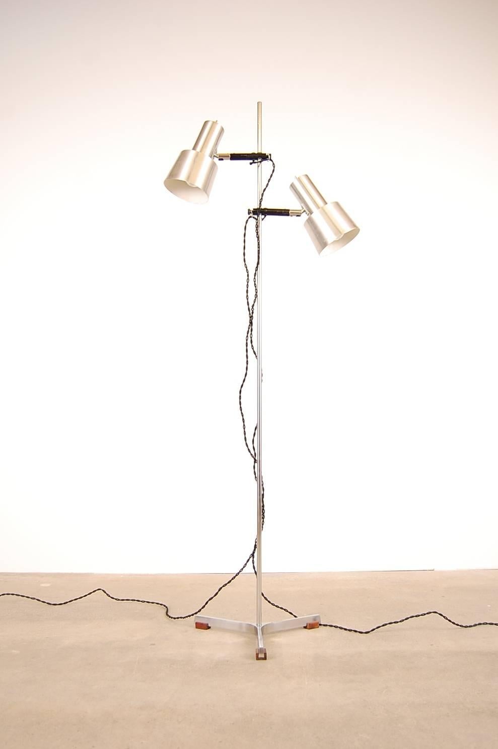 Floor lamp in stainless steel and teak by Fog and Mørup, circa 1966. Designed by Jo Hammerborg. Consists of two shades that are not only able to adjust height position on the main body, but are also able to be adjusted in numerous other ways as