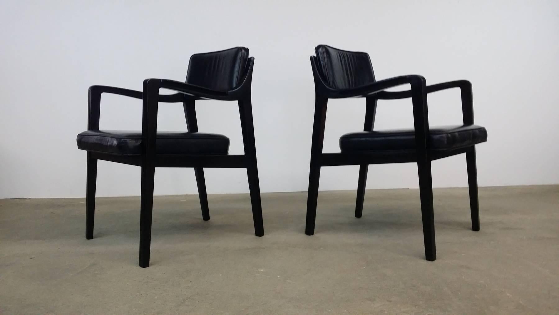 Pair of Dunbar chairs in mahogany and black leather, designed by Edward Wormley, circa 1966. Professionally refinished in a very dark, almost ebony finish. Original black leather in excellent condition.