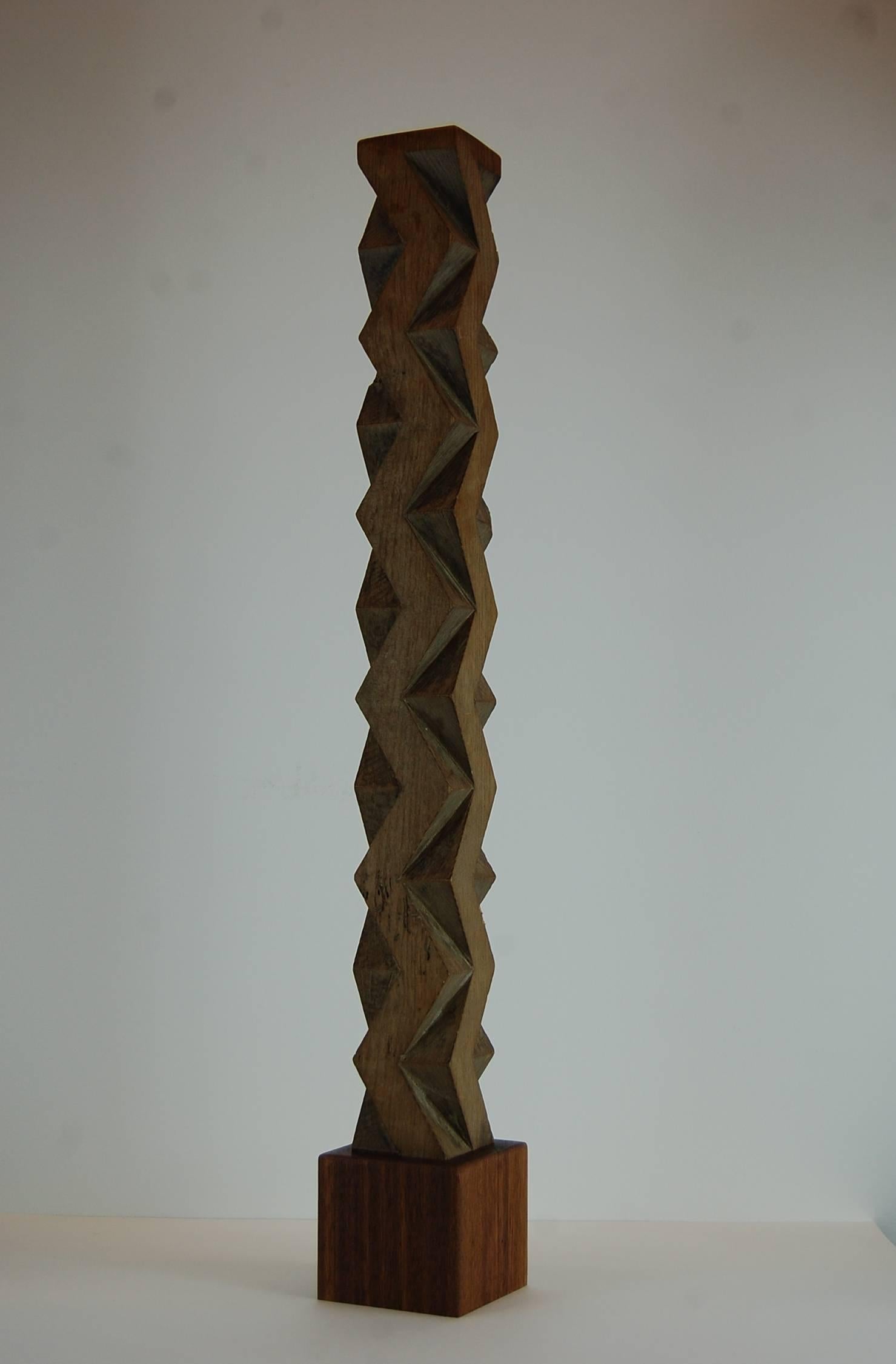 Carved sculpture in oak, manner of Constantin Brancusi, circa 1935. Carved oak element sits on a solid block of solid mahogany. Unsigned. 25 1/2" tall x 3 3/8" wide at base.