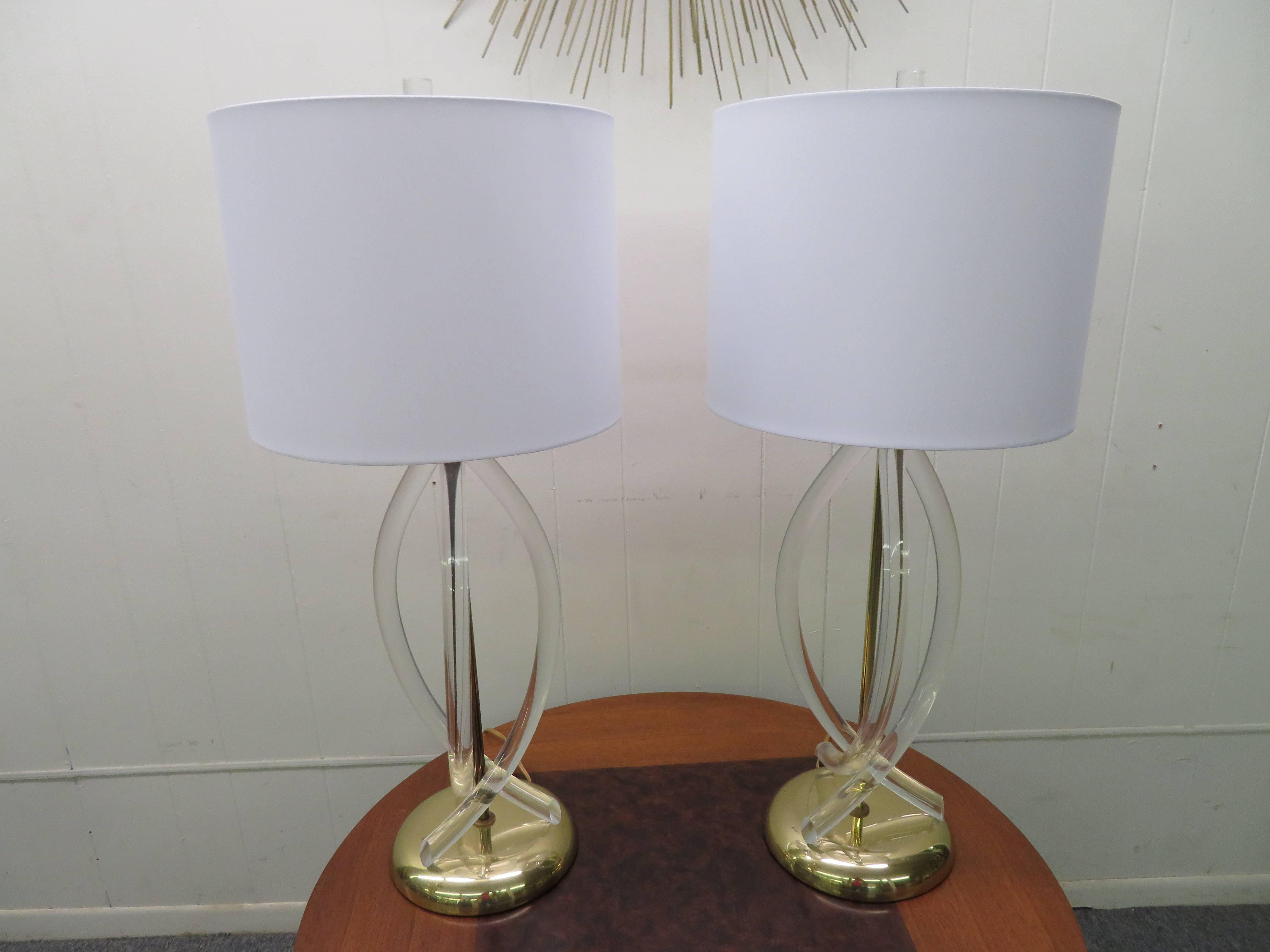 Stunning pair of Dorothy Thorpe Lucite and brass ribbon lamps. Gorgeous vintage condition, the Lucite is clear and the brass has a mellow patina. These lamps measure 33