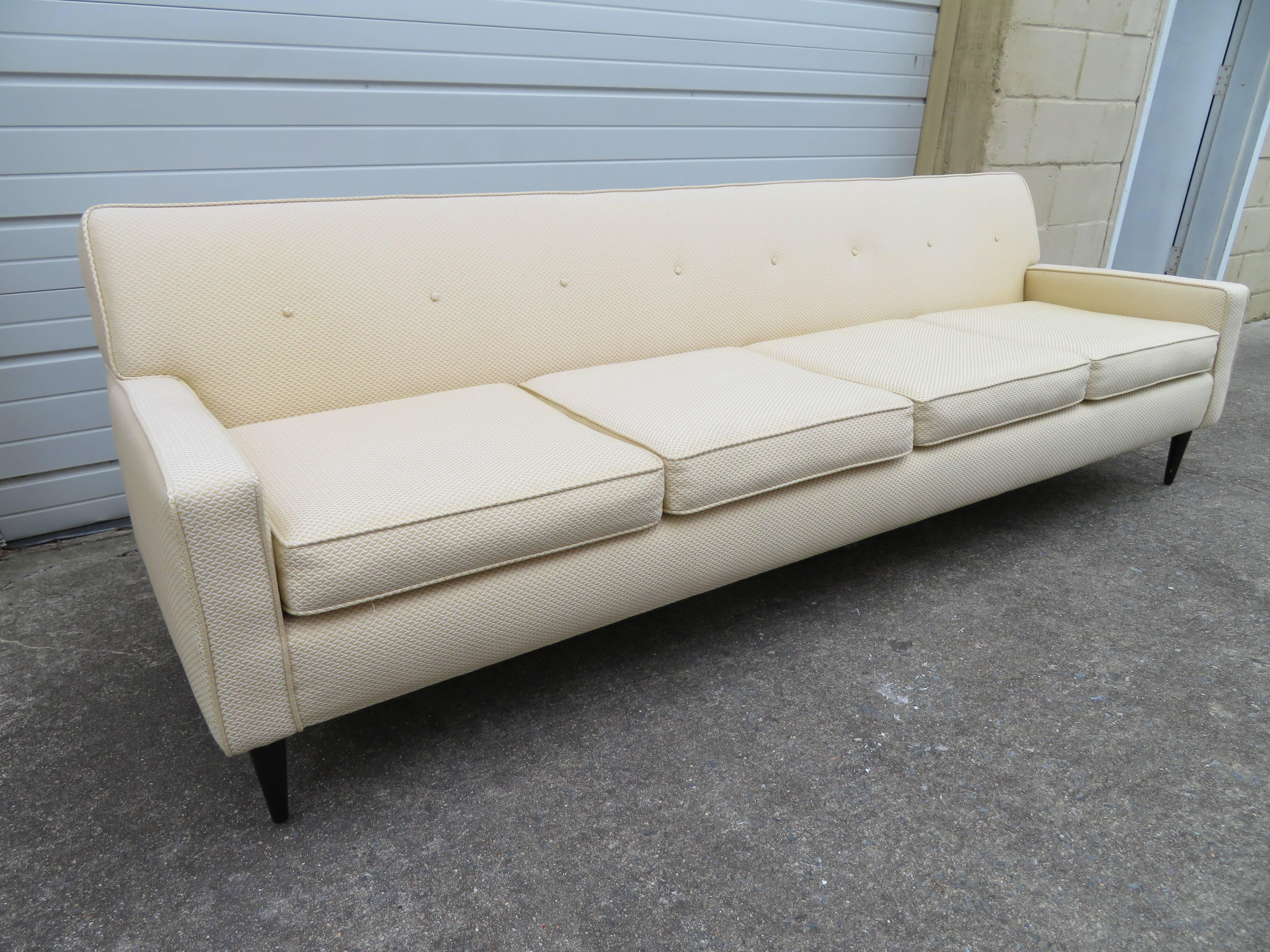 Handsome Harvey Probber style four-seat sofa with black lacquered tapered legs. Original white woven fabric still looks great with only light wear-very comfortable too. Please check out the matching fabric Probber style chairs listed in another of