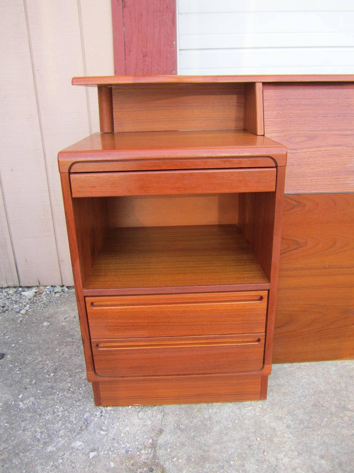 Fantastic Danish modern teak kingsize headboard with attached night stands by Torring.  This headboard is well constructed and the nightstands have fabulous pull out trays that slide out on an angle to use while in bed-how ingenious.  There is also