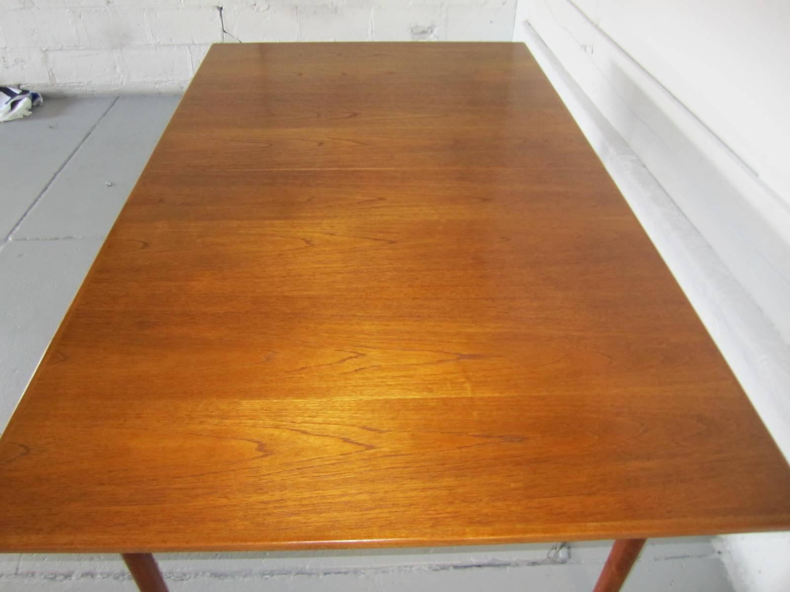 Stunning Sylve Stenquist Dux teak dining table with 2 leaves.  This one-owner table will show beautifully in modern or more traditional settings. The table is handsome and sturdy and has two 18