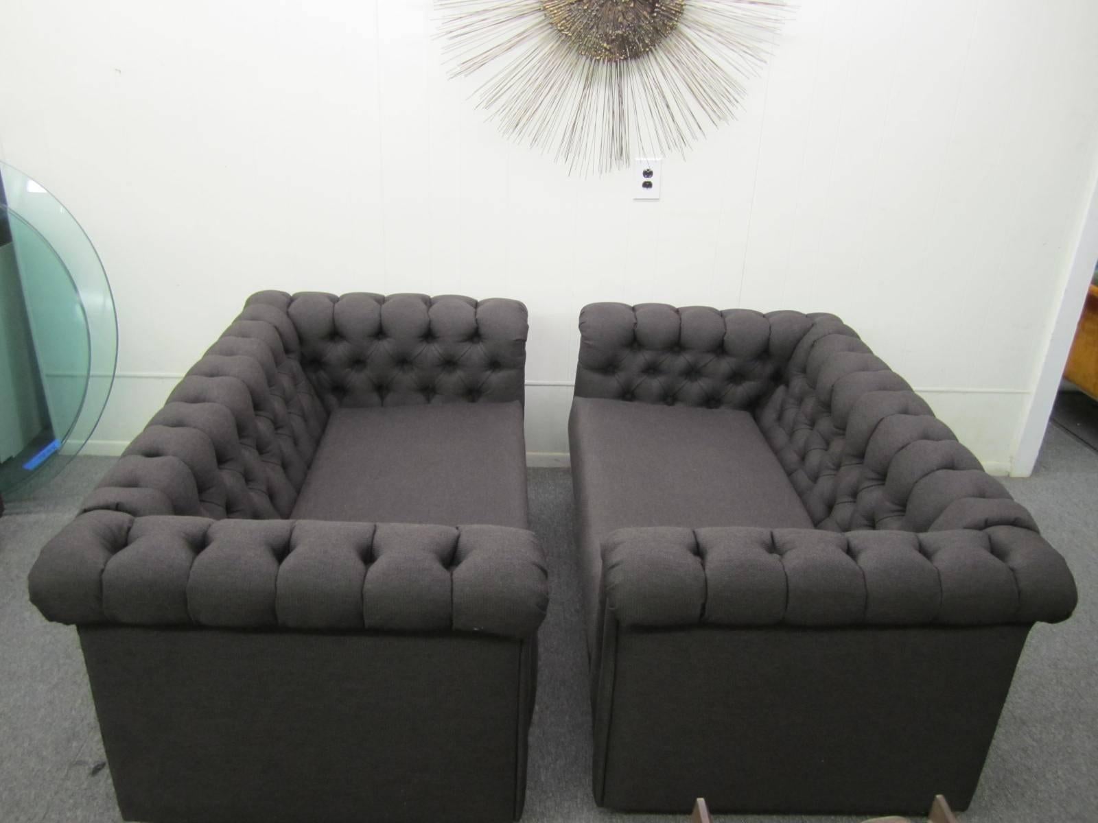 Stylish pair of Harvey Probber style Chesterfield loveseat sofas. Both have newer charcoal black woven fabric in very nice condition. Castors on the underside make moving them around a snap. This pair is ready to slip right into your Mid-Century