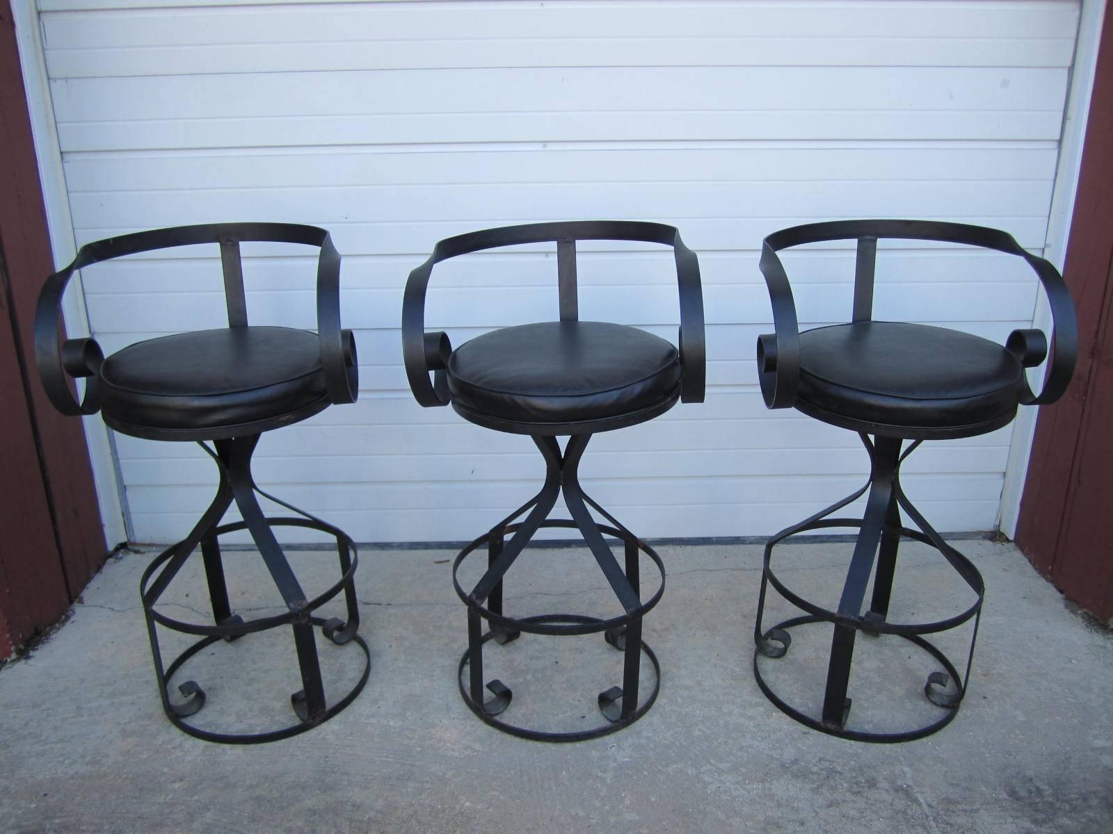 Fantastic set of five Mulhauser Sultana style iron barstools. Great looking faux black leather swivel seats look perfect on the curly armed iron bases. These are true barstools having a seat height of 29