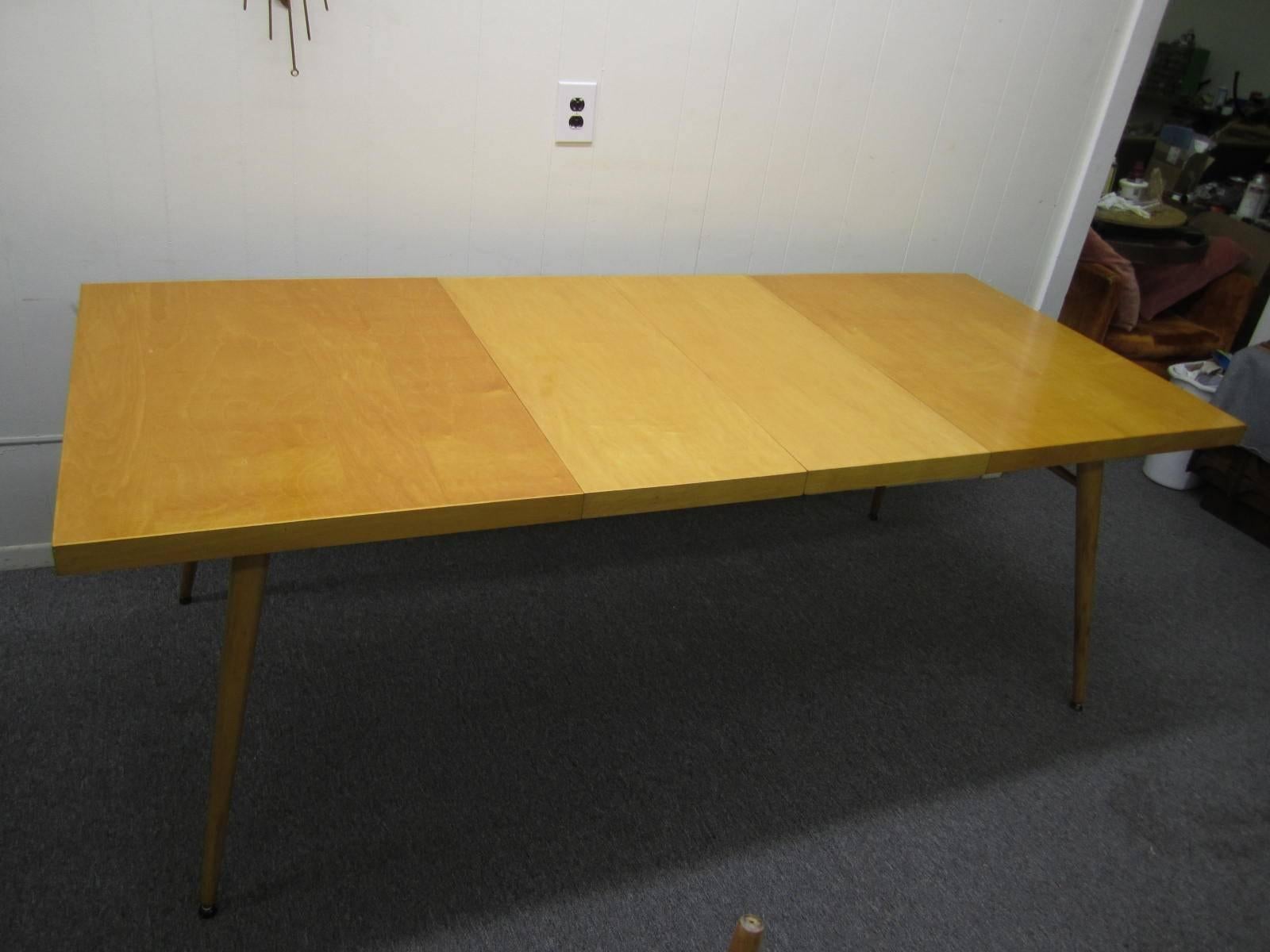 Lovely signed Paul McCobb maple extension dining table with two leaves. This table has two 15