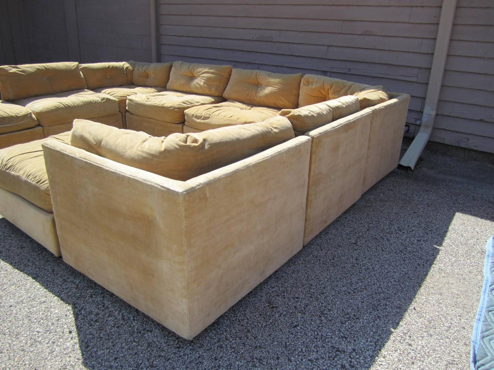 Fabulous nine-piece Milo Baughman style cube sectional sofa. These pieces retain their original tan velvet in usable condition-reupholstery recommended. The sofa sections have wonderful wooden legs and the two ottomans have castors. Each piece