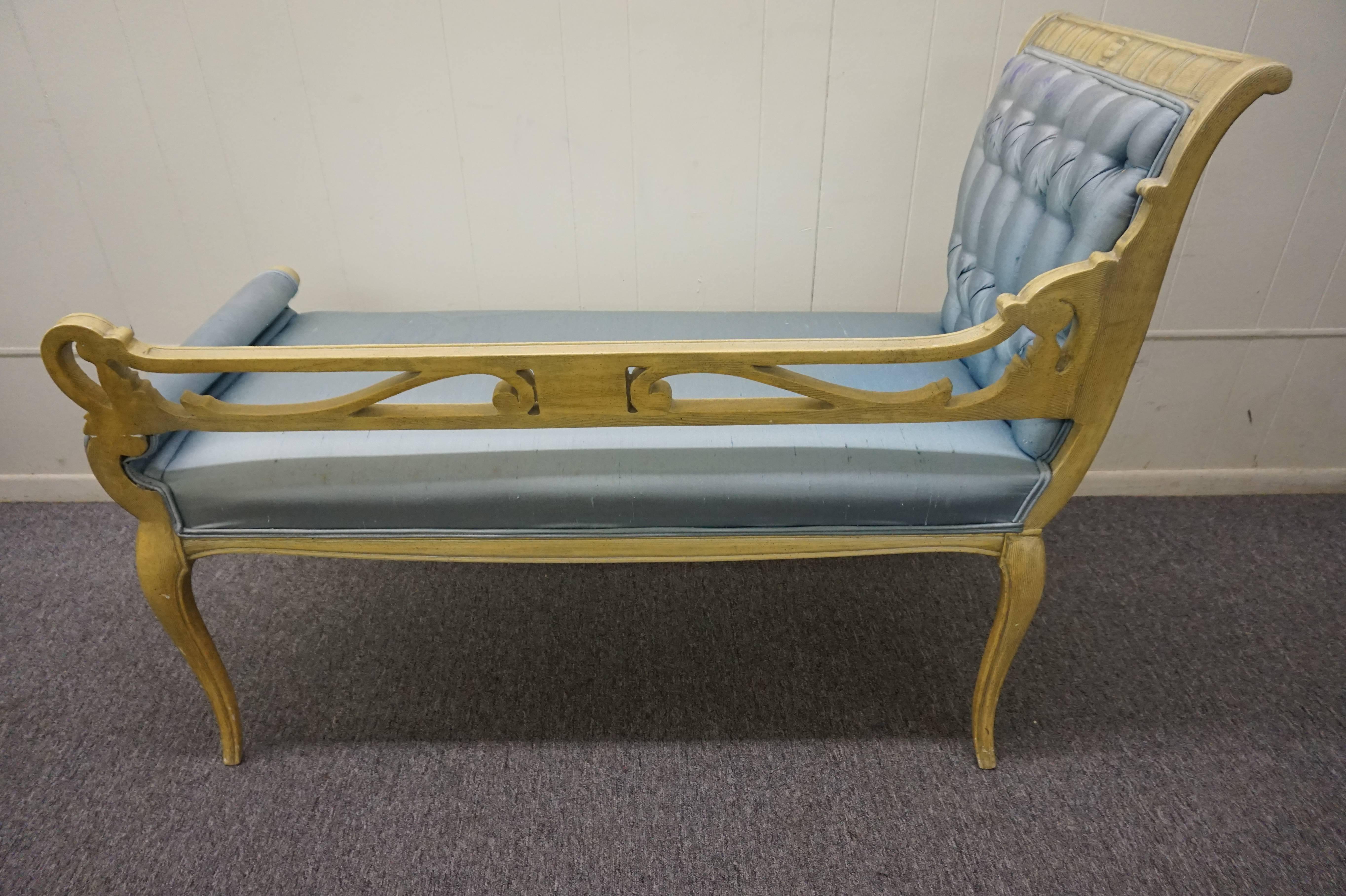 Lovely Hollywood Regency scrolled arm carved wood bench. Gorgeous cabriolet legs with one tall tufted scrolled arm. The blue satin fabric has seen better days but that means it just right for you designers who need to have everything reupholstered