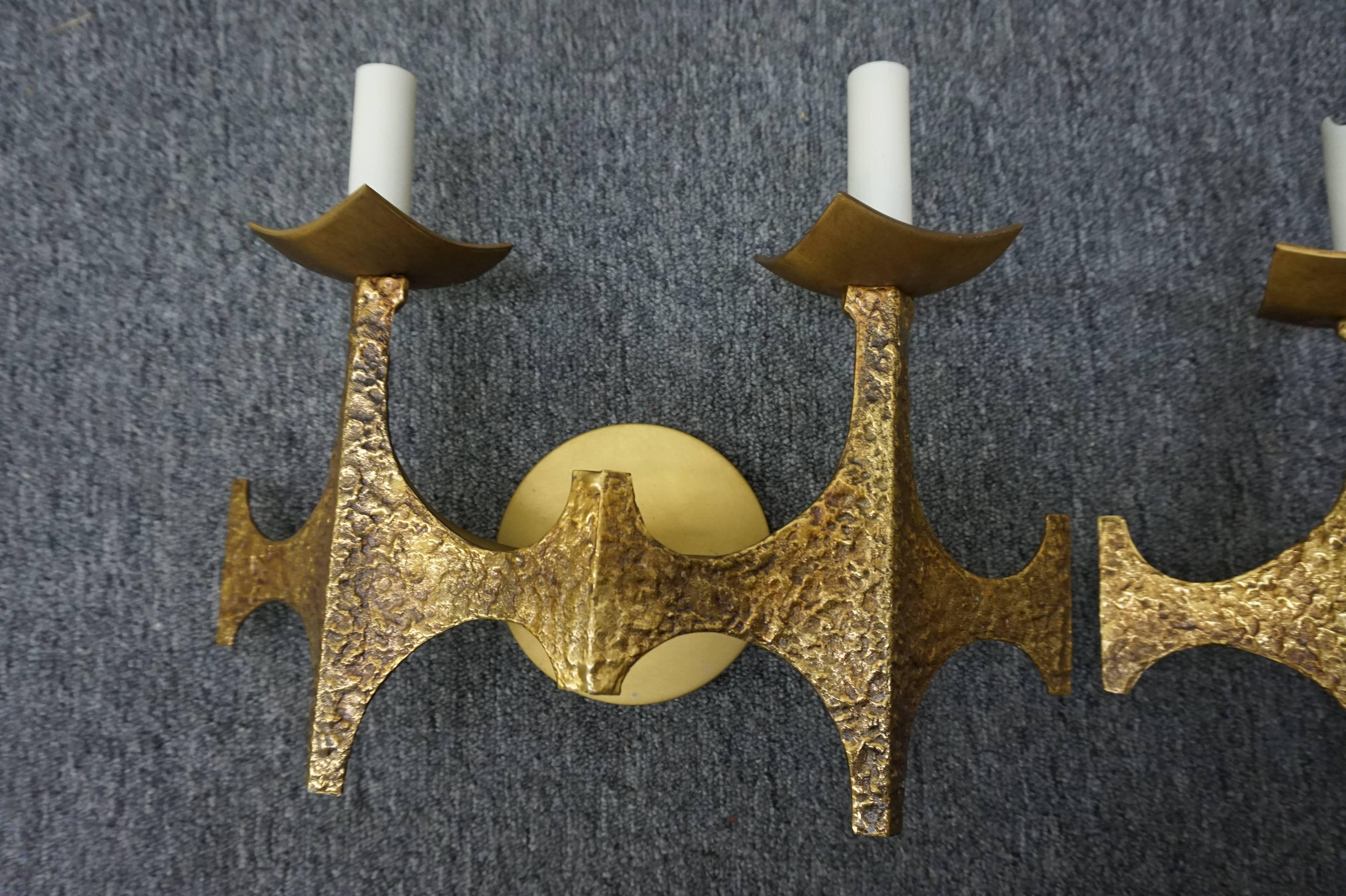 Pair of decorative Brutalist brass sconces, circa 1950. Wonderful hammered brass in a Gothic style-excellent vintage appeal.