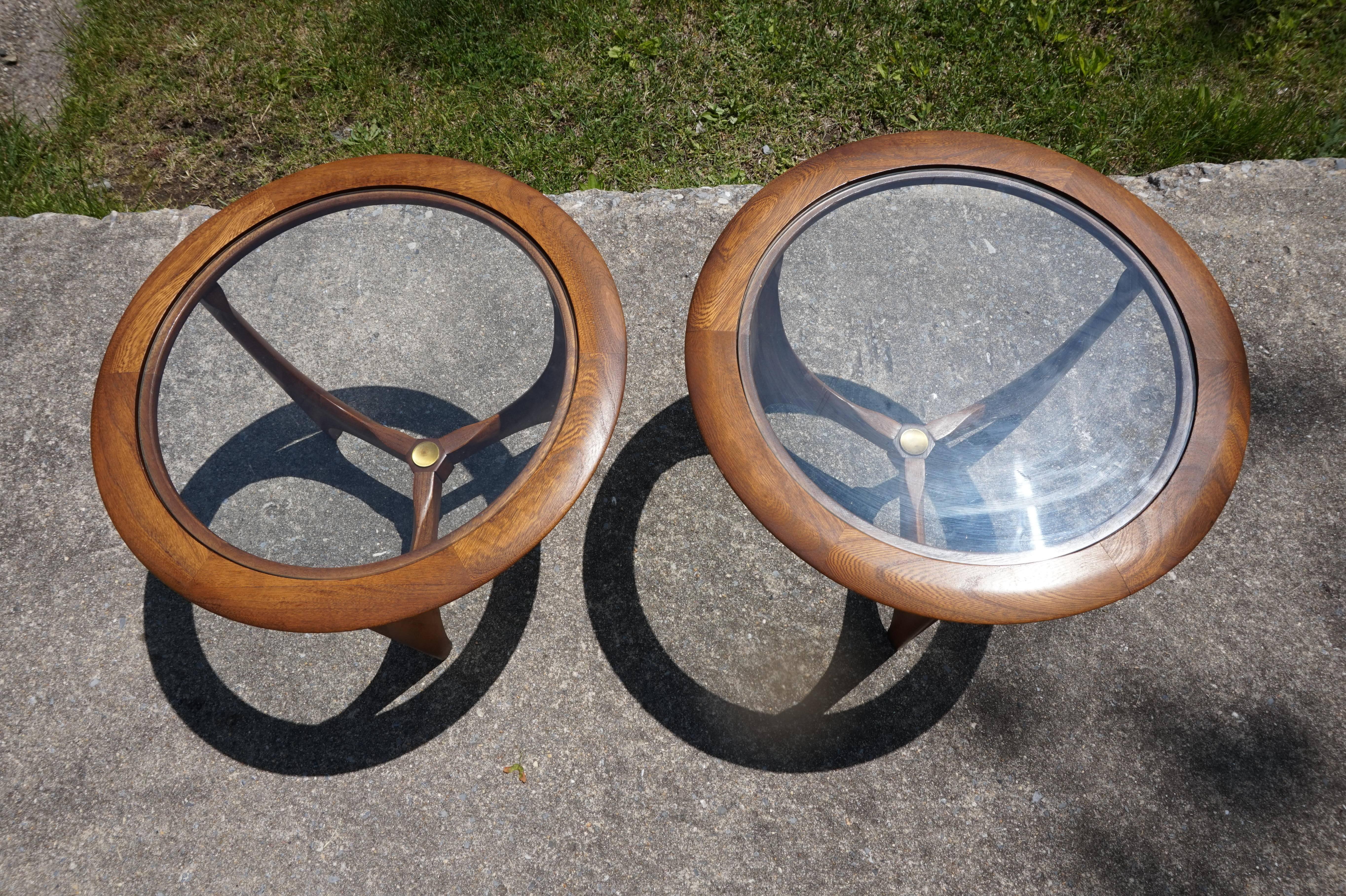 Lovely pair of petite round side tables by Lane. Tables have gorgeous sculptural light walnut with original finish and brass medallions intact. Tables measure 14.5