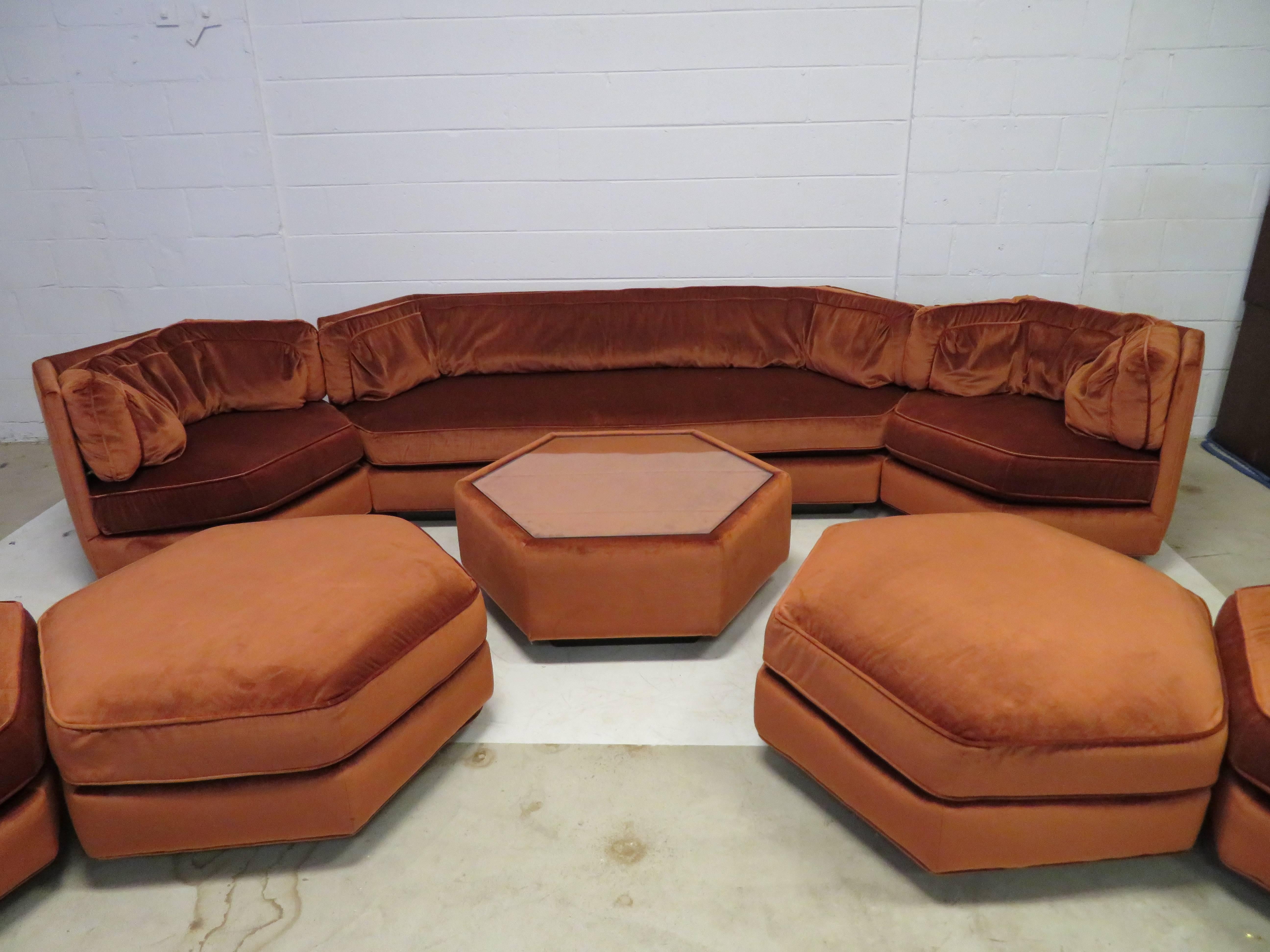 Spectacular Milo Baughman style octagon sofa with four chairs, two ottomans and matching coffee table. This amazing set is a sight to behold in it's original rust colored velvet. I am sure there will never be a set so large and complete offered for