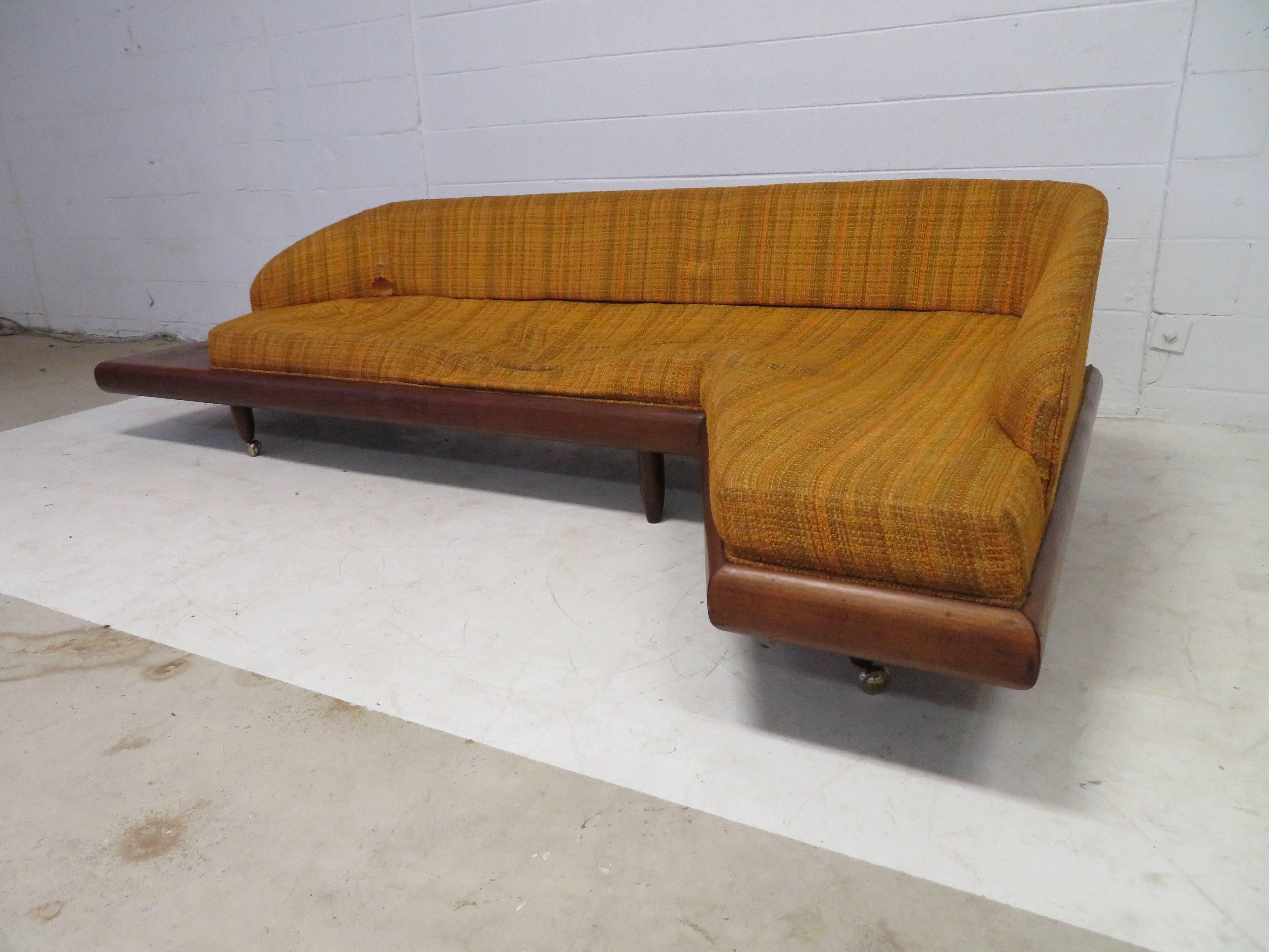 Very unusual Adrian Pearsall sculptural walnut boomerang sofa with attached side table. Of-course this will need to be re-upholstered but this is the perfect high style sofa to do! We love the small attached side table on one side and tiny finished
