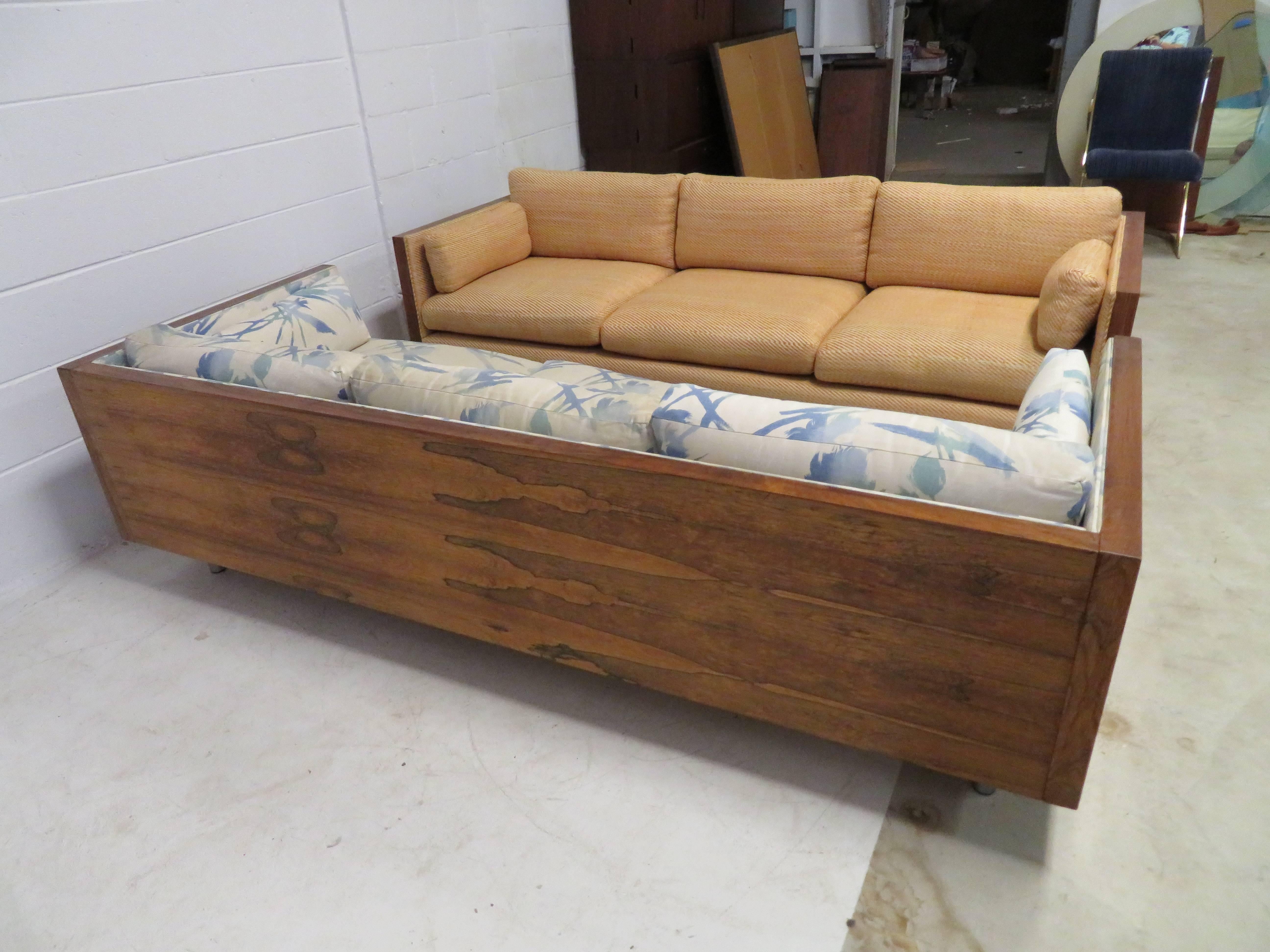 Gorgeous pair of Milo Baughman style rosewood case sofas. Each sofa is in very nice original vintage condition retaining their original finish and upholstery. They will both need upholstery but that's what you designers are looking for anyway-right?