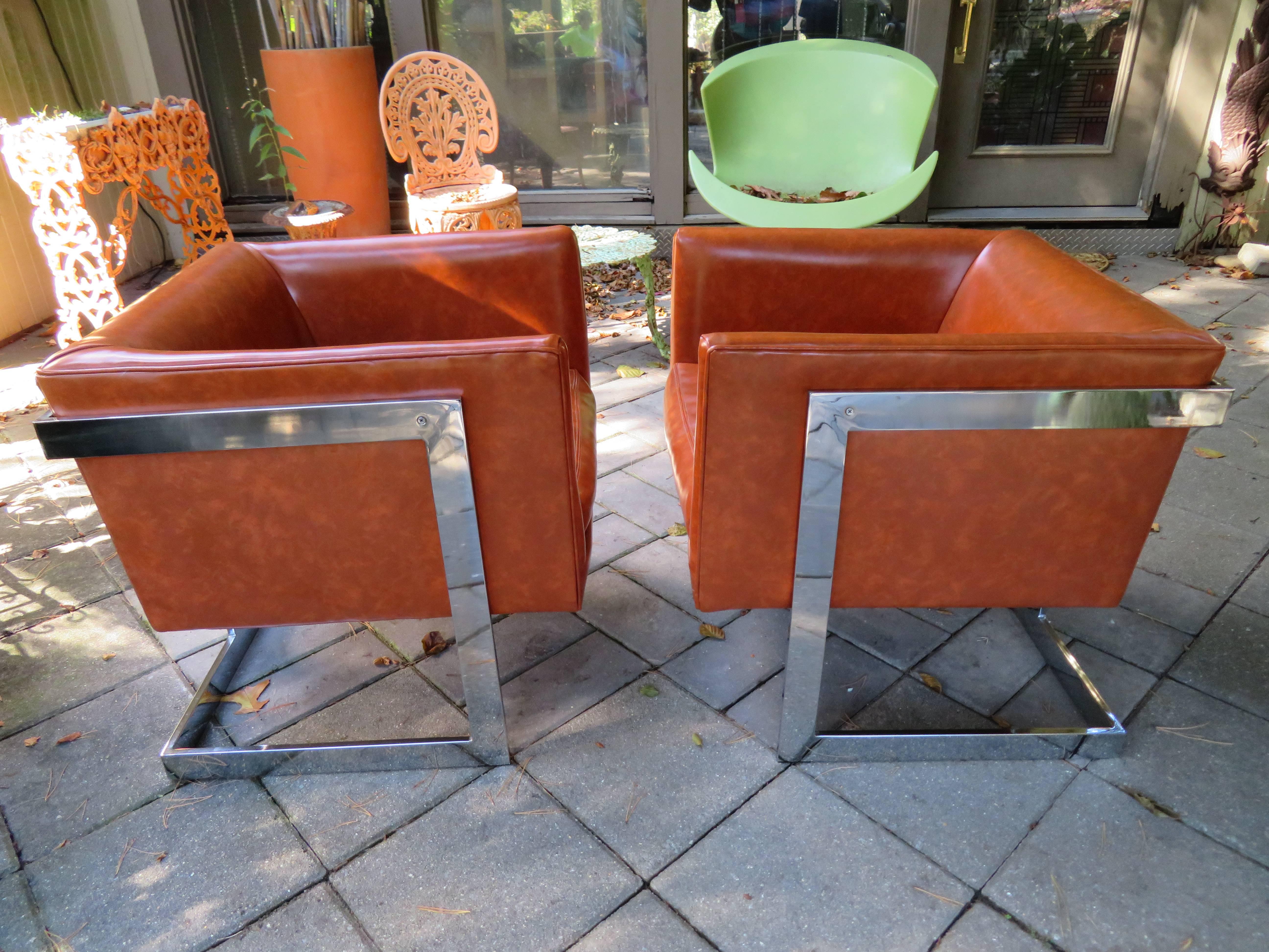 Stunning pair of signed Milo Baughman Thayer Coggin chrome cube chairs. The original vinyl shows wear and re-upholstery is recommended.   Thayer Coggin tags are still on the underside.
