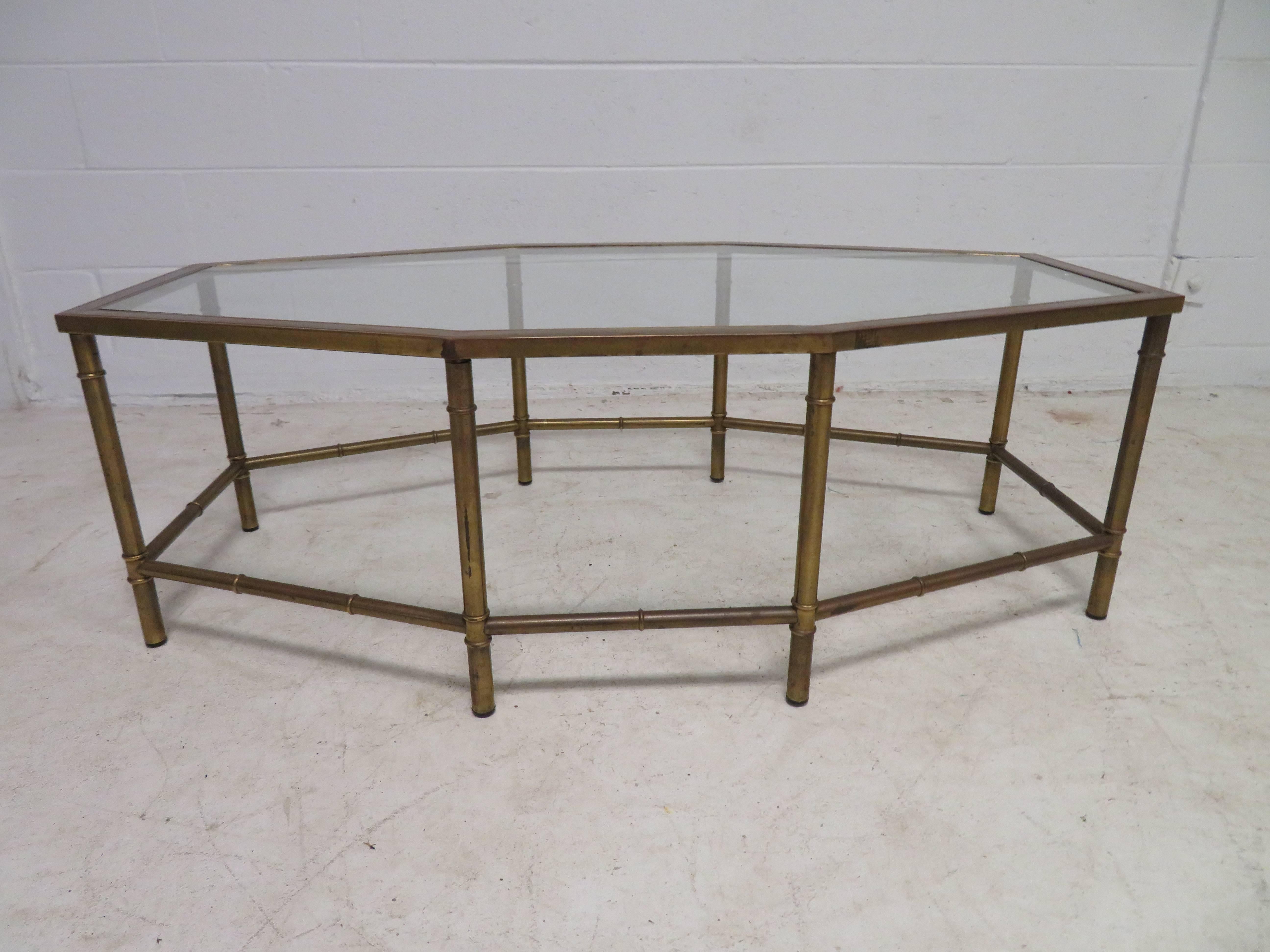 Lovely mastercraft patinated brass oval octagon coffee table. This piece measures 17