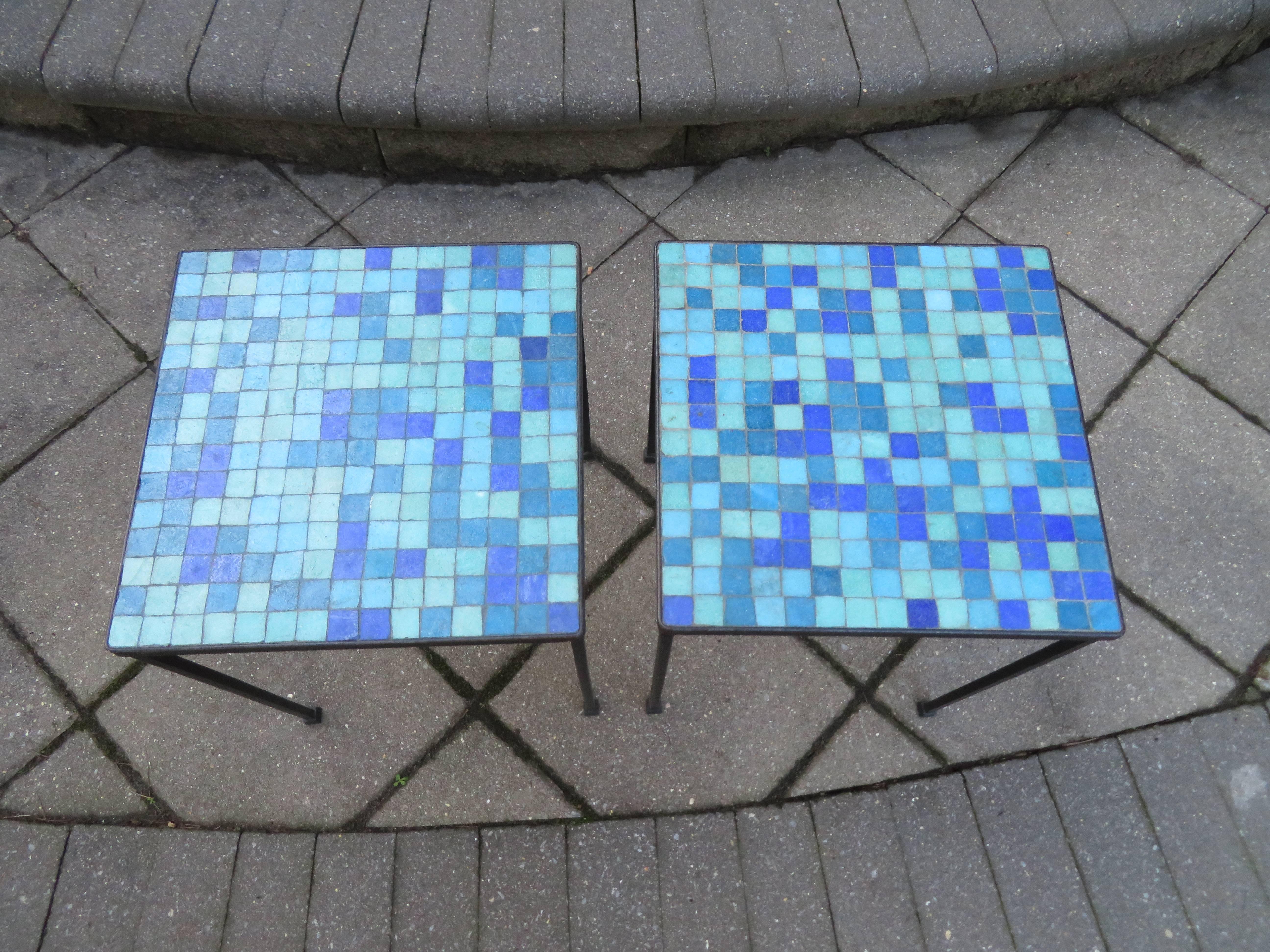 Wonderful pair of Paul McCobb style mosaic tile top side tables. This pair have nice black iron bases with fantastic mosaic glass tile tops in shades of blue and turquoise-adds great vintage appeal to any decor.