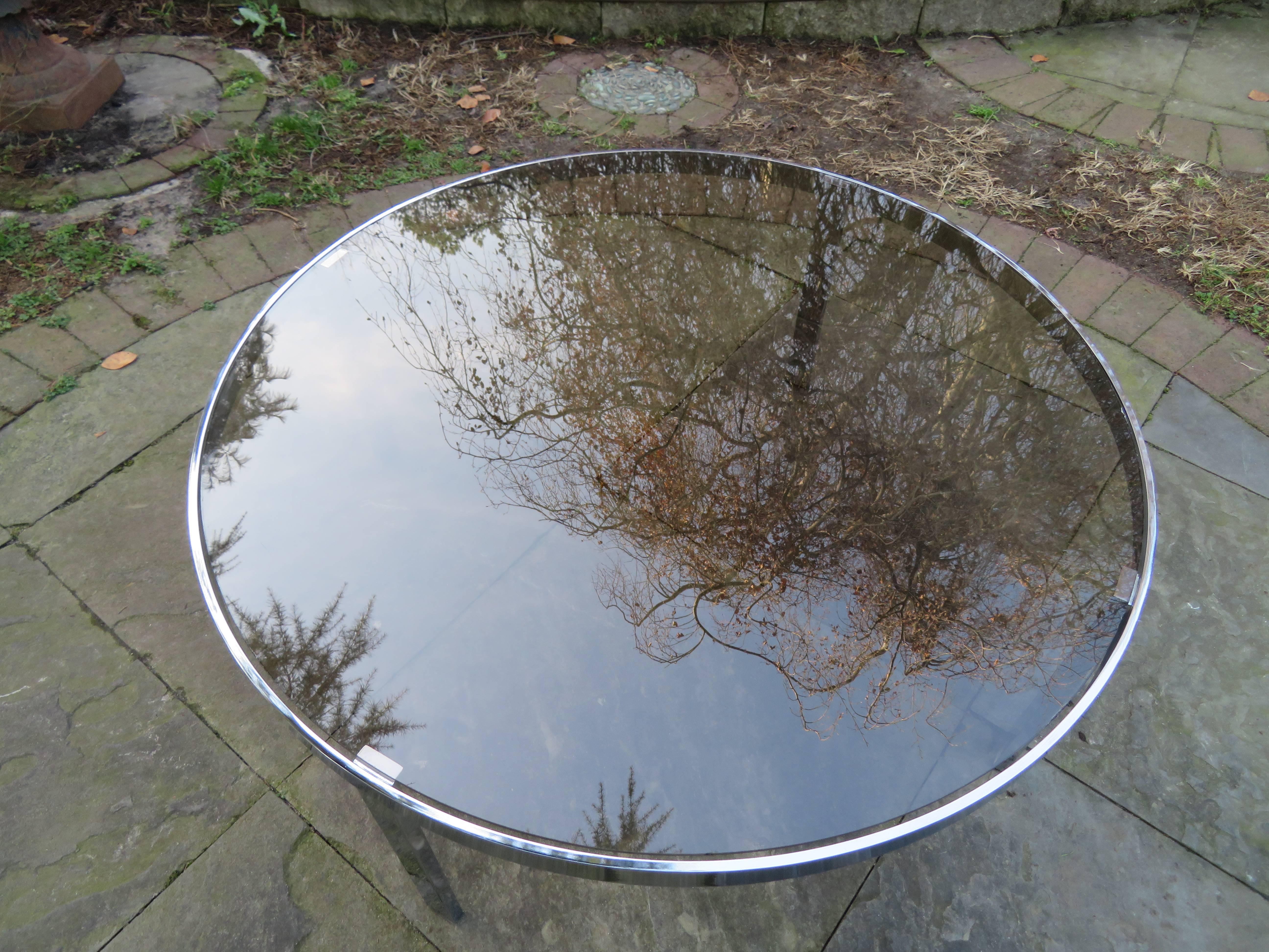 Sexy Milo Baughman round chrome coffee table with smoked glass. Chrome base is in very nice vintage condition with a polished mirror finish.