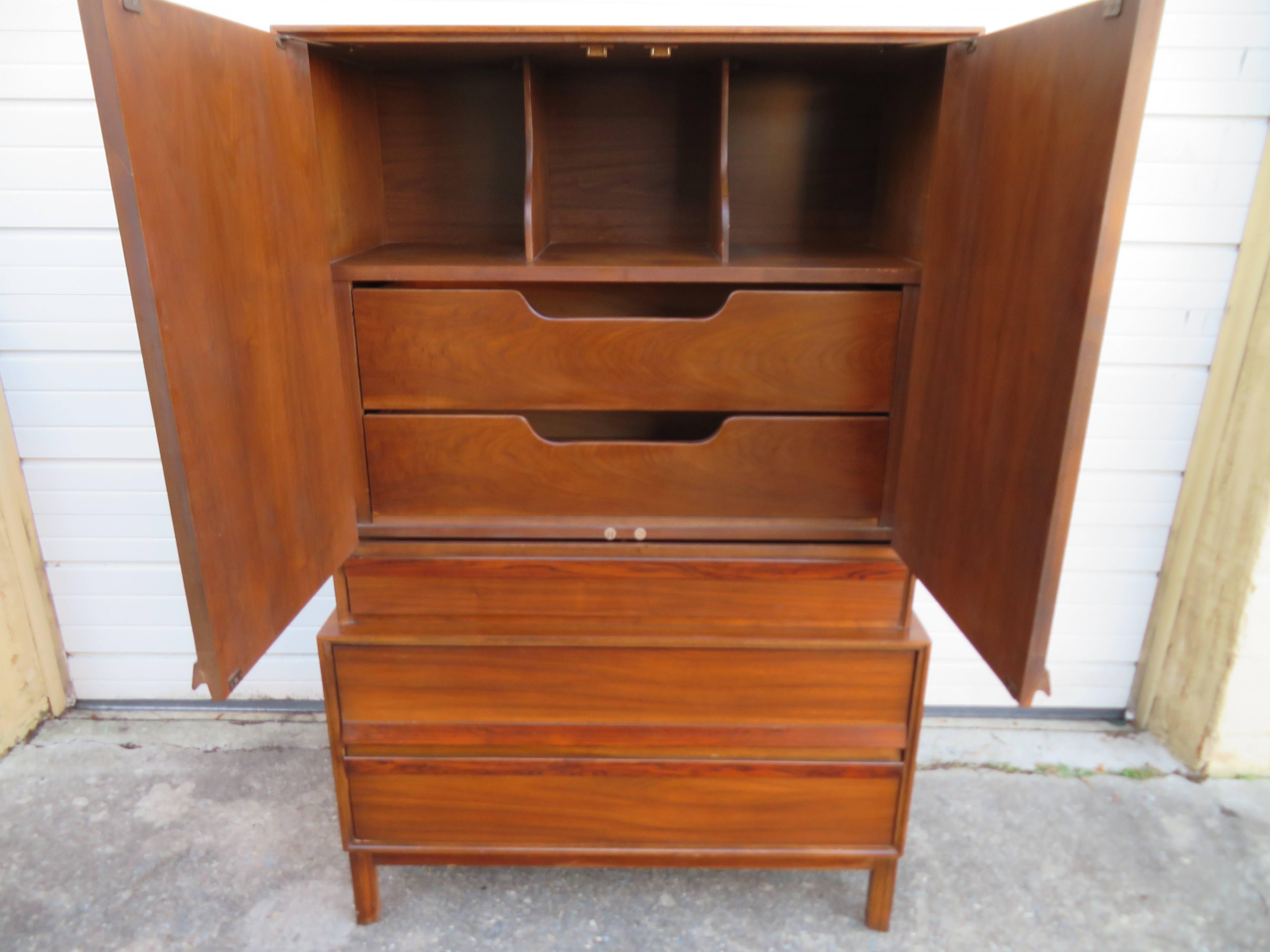 Handsome Mid-Century Modern tall walnut and rosewood American of Martinsville chest of drawers dresser. We love the simple linear lines of this well crafted tall chest of drawers with built in rosewood pulls. Check out all the wonderful storage