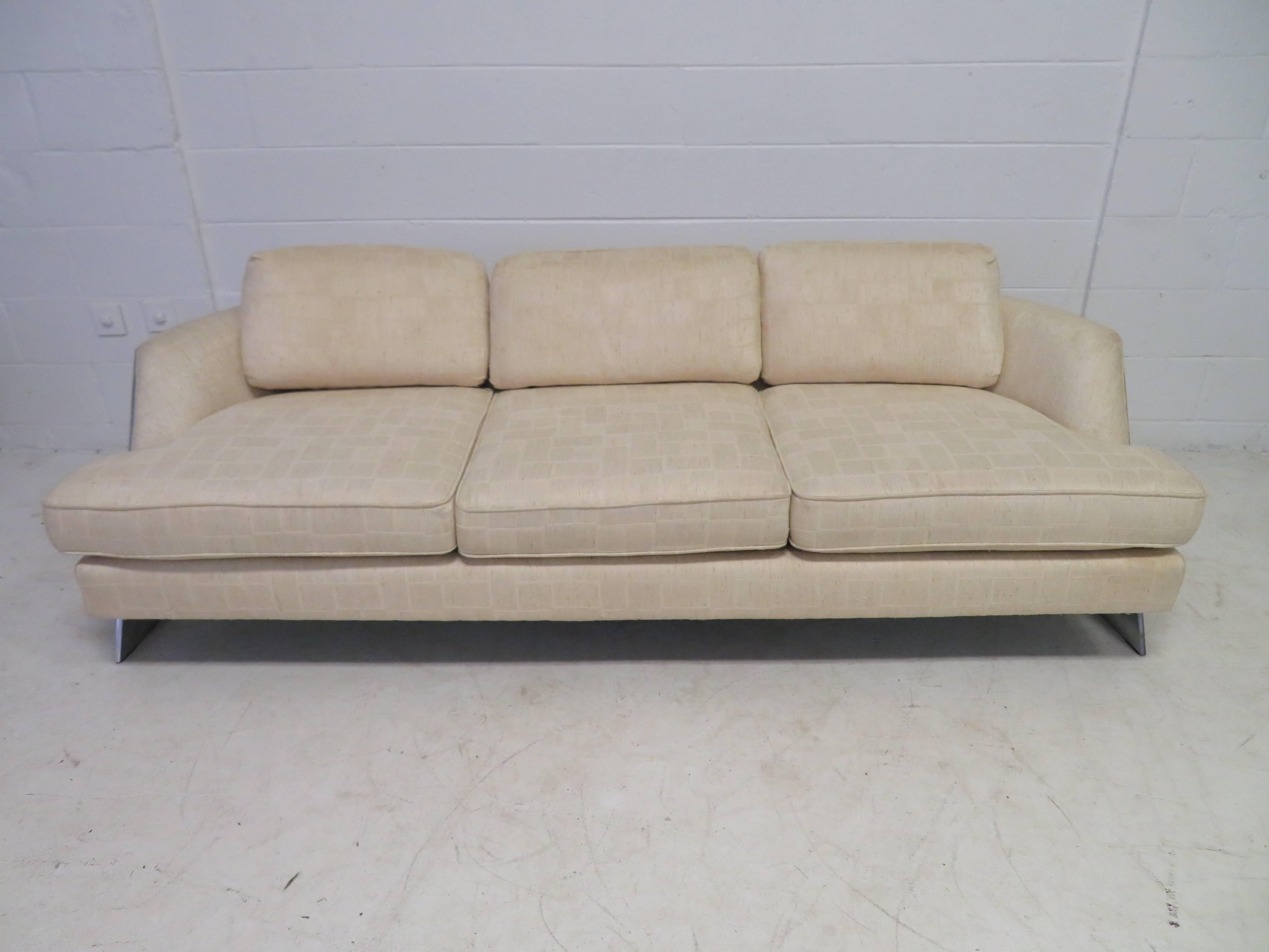 Excellent Milo Baughman curved chromed leg sofa. Very unusual curved chrome legs on either side give this sofa tremendous mid-century appeal-very sexy! This sofa retains it's original oatmeal textured fabric in usable condition-re-upholstery is