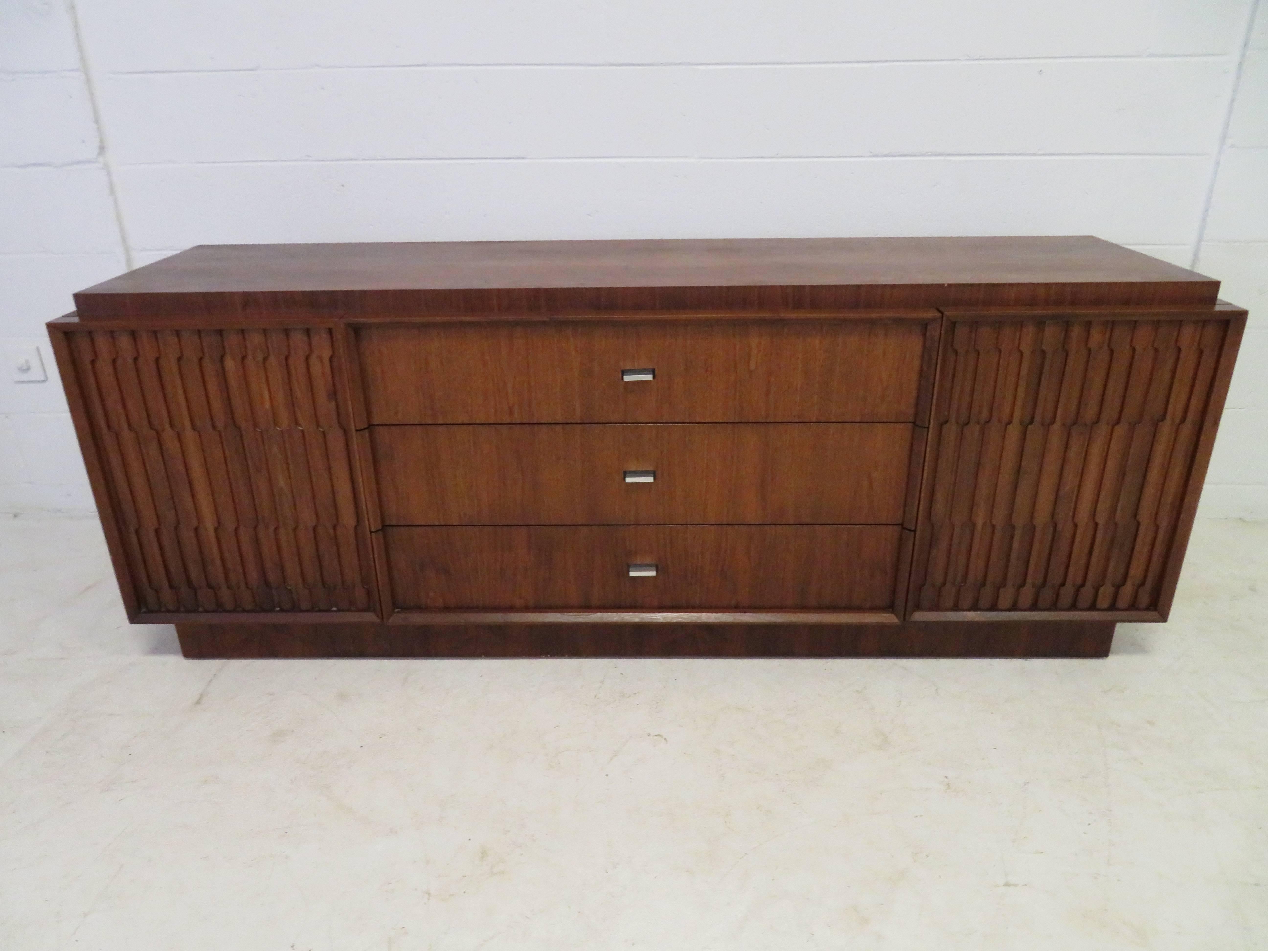 Handsome American modern Brutalist walnut credenza with tons of storage options-just look at all those drawers! We love the straight lines against the textural sculpted door fronts. Please check out the other matching pieces we have to this