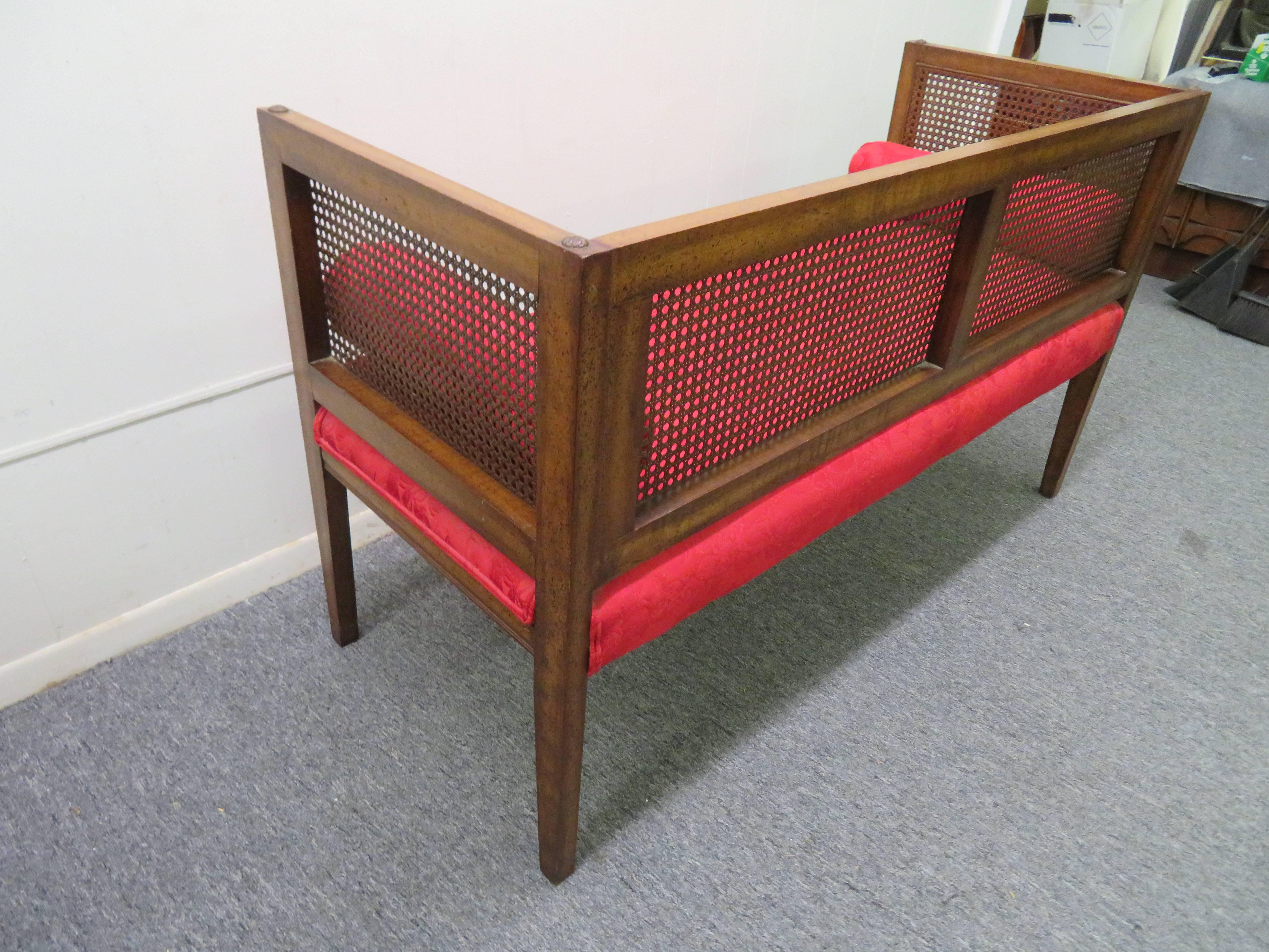 Gorgeous Hollywood Regency boxy caned bench. The cushions will need to be reupholstered but the caning is in fine condition. This piece retains its original distressed finish and still looks fine-great vintage appeal.