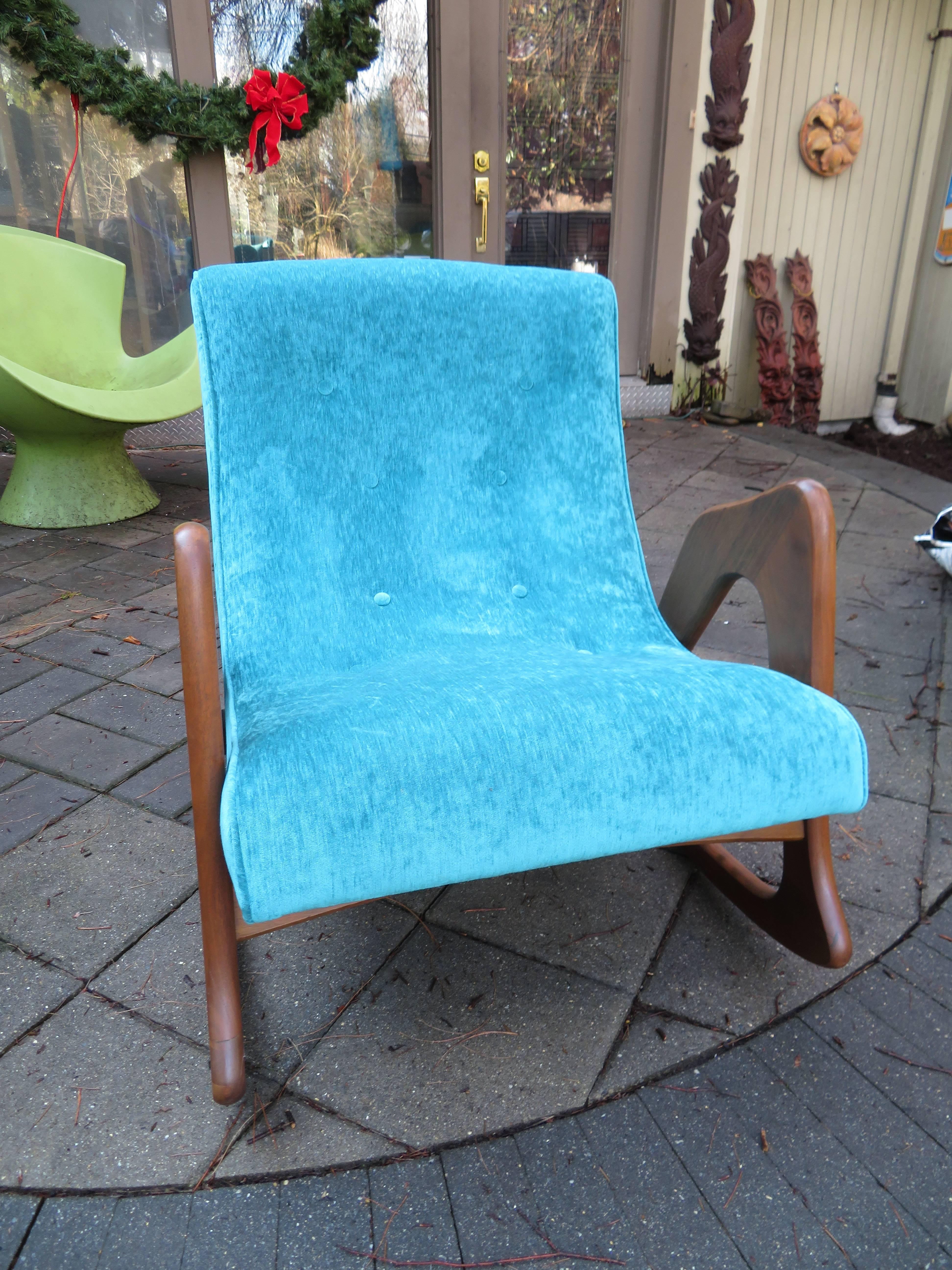 Spectacular Adrian Pearsall walnut rocking chair for Craft Associates. This fabulous sculptural rocker is in great restored condition. The high end woven turquoise upholstery and foam are brand new. The base has been refinished and looks great!