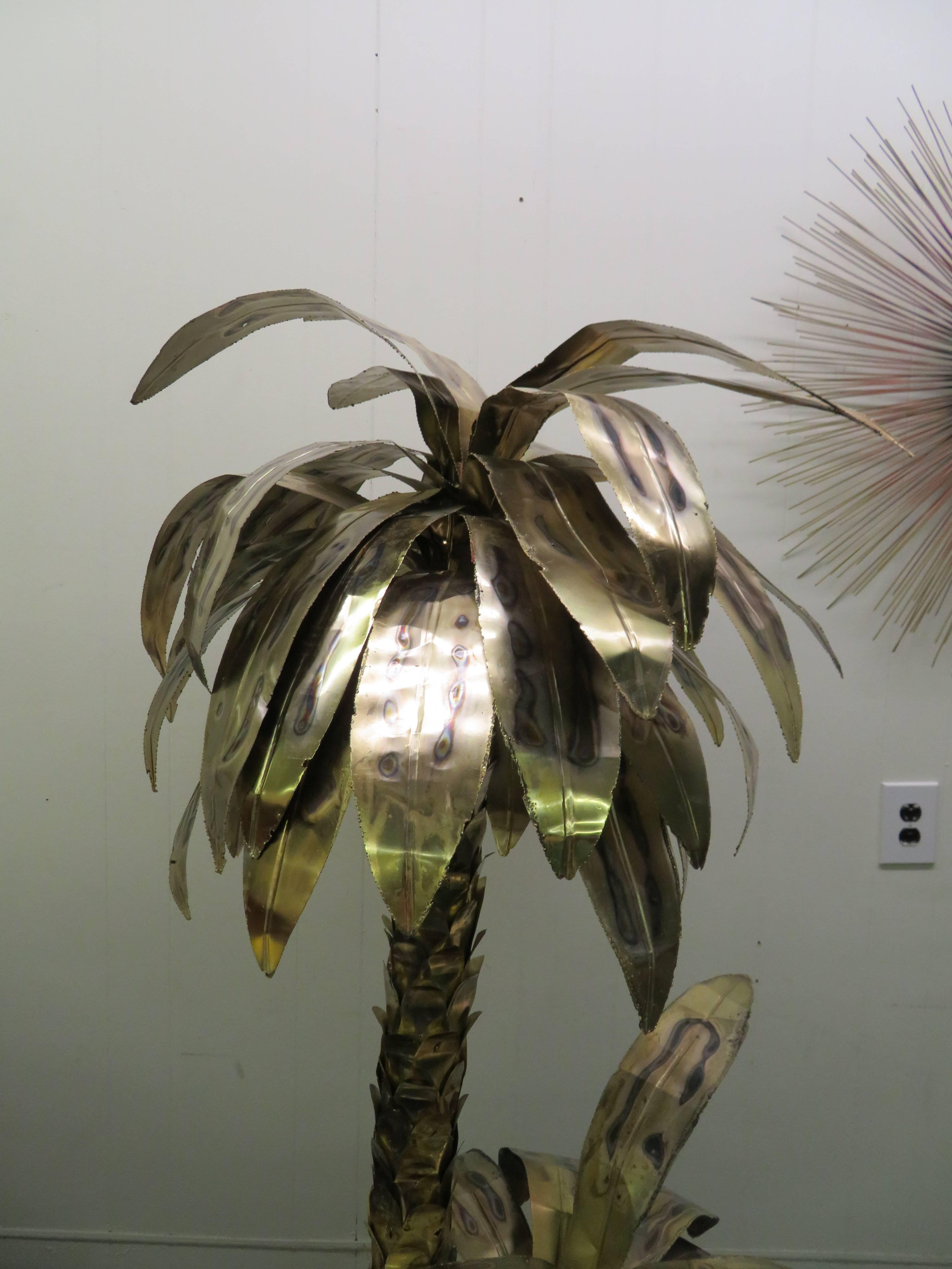 A giant sculptural brass palm tree with shiny torch cut leaves attributed to Curtis Jere, circa 1970.