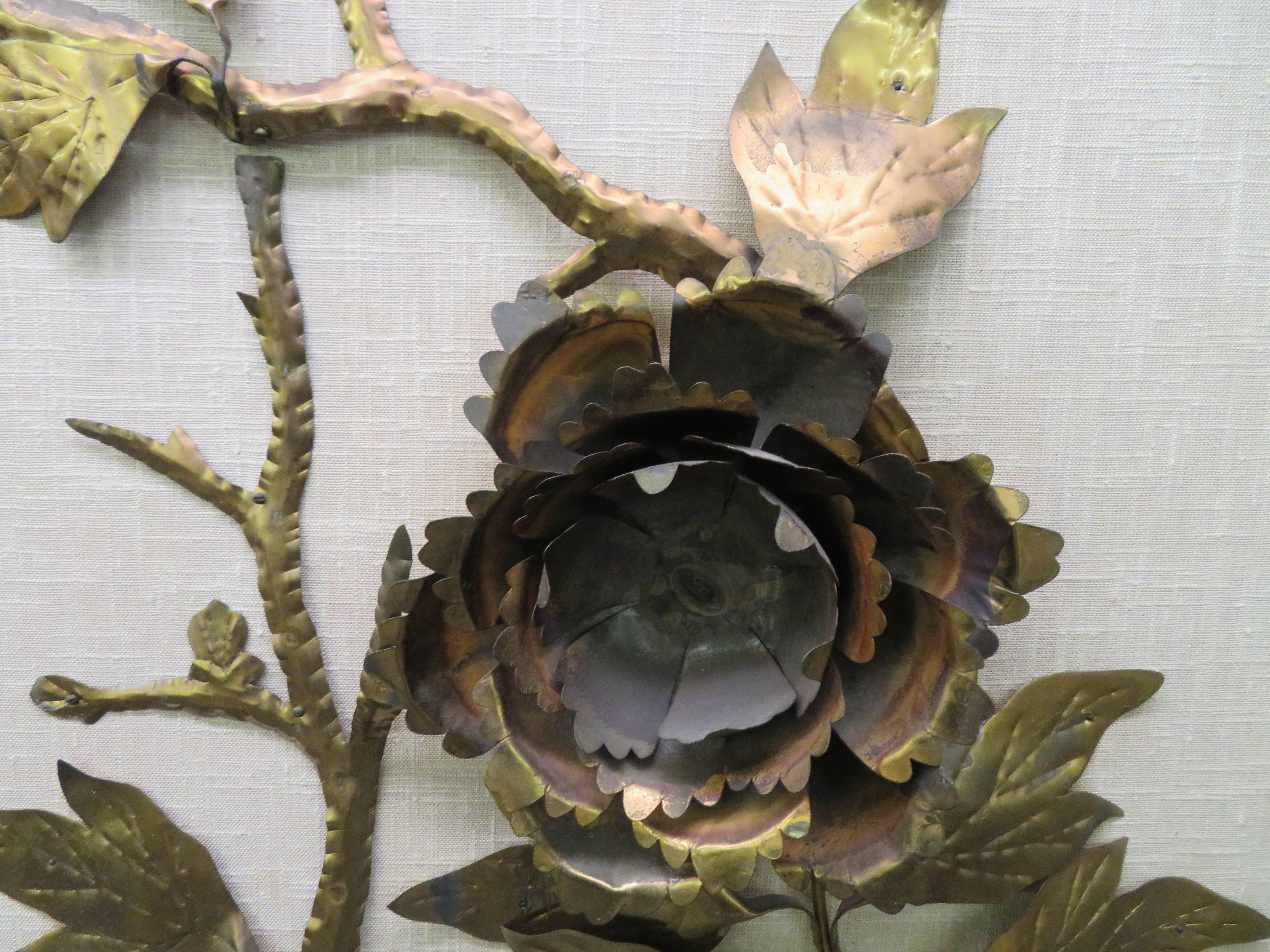 Stunning large scale Curtis Jere style brutalist brass peony flower wall hanging. 3 dimensional sculptural peony flowers are displayed on a linen background all surrounded by a black painted frame. Mid-Century