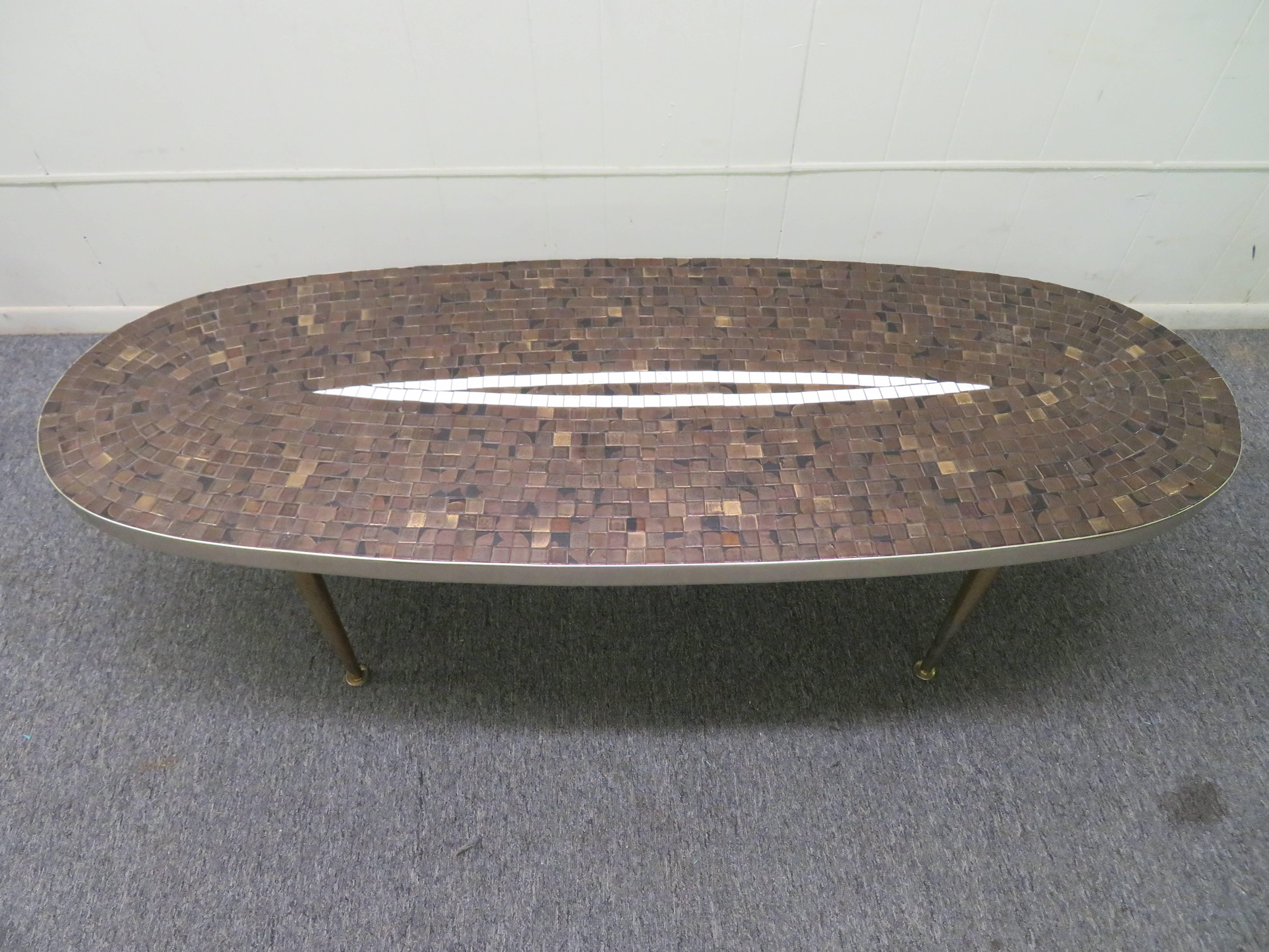 Great Mid-Century tile-top coffee, cocktail table. Metallic glaze tile, in a modernist pattern. Very good original condition, brass legs shows pagination, normal and consistent with age.
