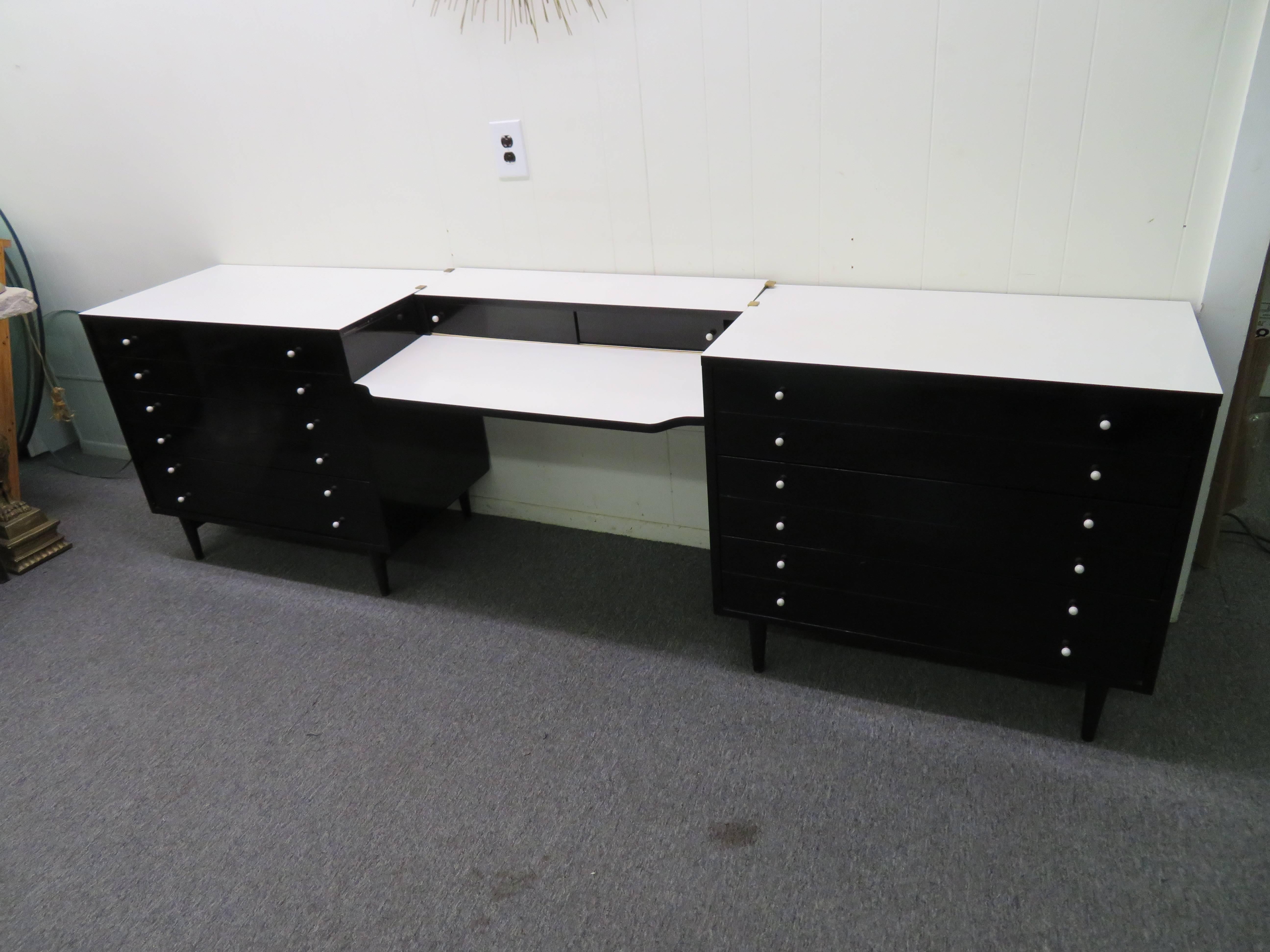 Excellent pair of American of Martinsville black lacquered bachelors chests. These chest have wonderful white formica tops that add great contrast to the black lacquered finish. These chests are in fantastic vintage condition and this sale include
