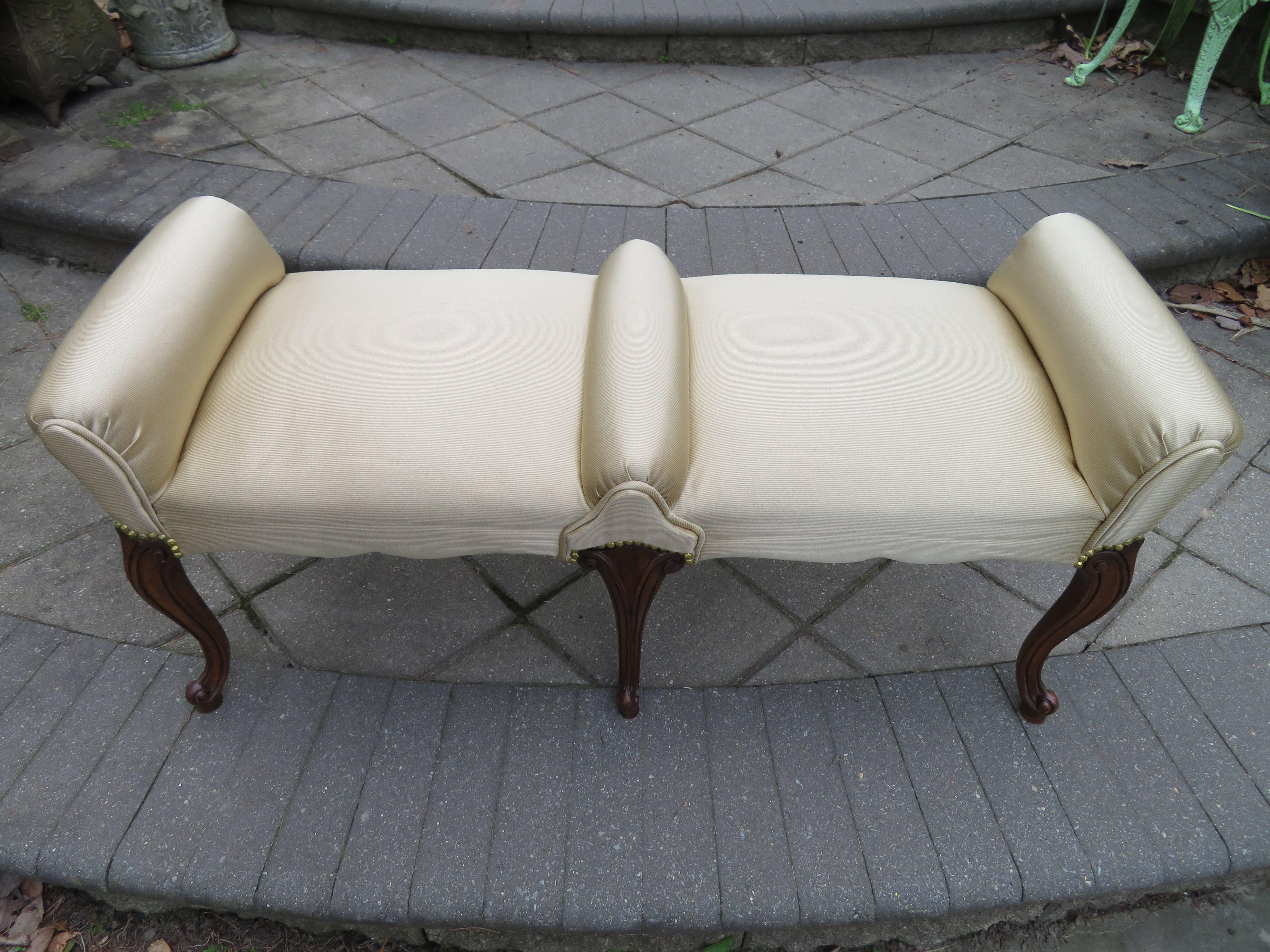 Elegant Regency modern cabriolet leg upholstered bench. Magnificent in person with well sculpted cabriolet walnut legs and scrumptious upholstered double divided seat-very unusual.
