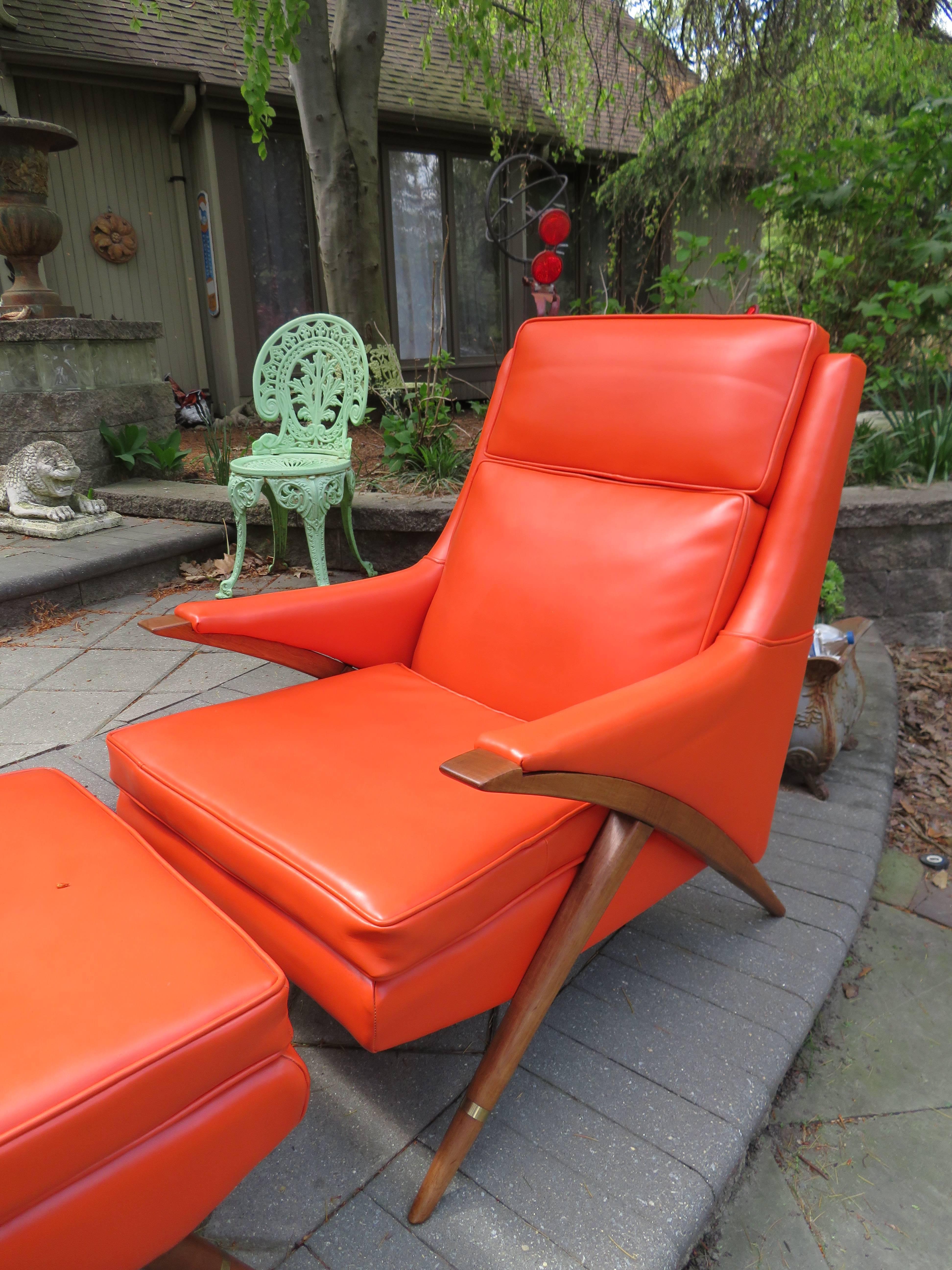 Awesome pair Momma Poppa bear style Karpen lounge chairs with matching ottoman. This set is in spectacular vintage condition retaining their original orange faux leather. The legs are also in gorgeous condition along with the lovely brass details.