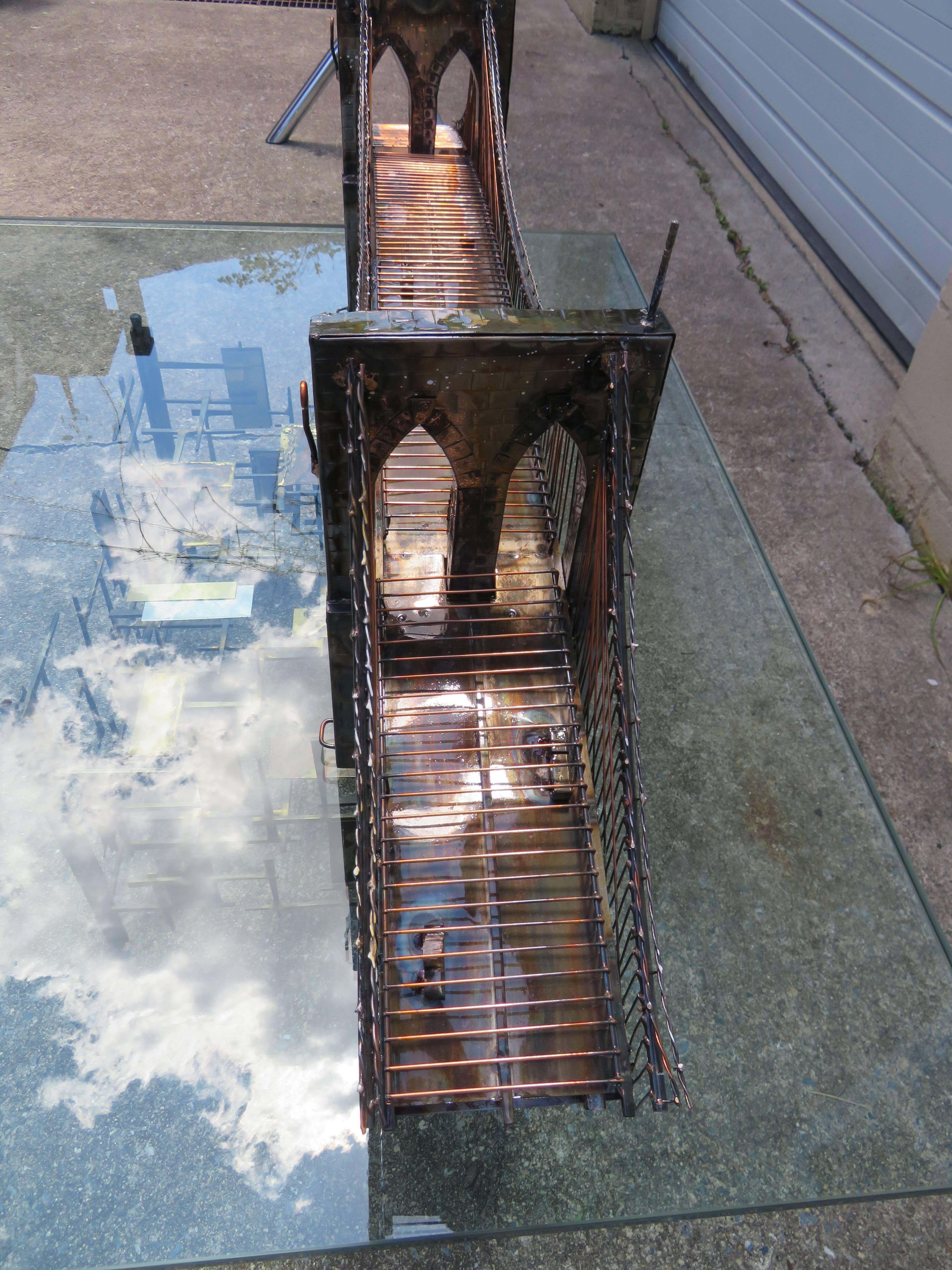 Wonderfully detailed mixed metal sculpture of the Brooklyn bridge made by the skillful but little know artist Ray bergere. This piece was from the artist’s personal collection and was his masterpiece. It won him many awards and was even displayed in