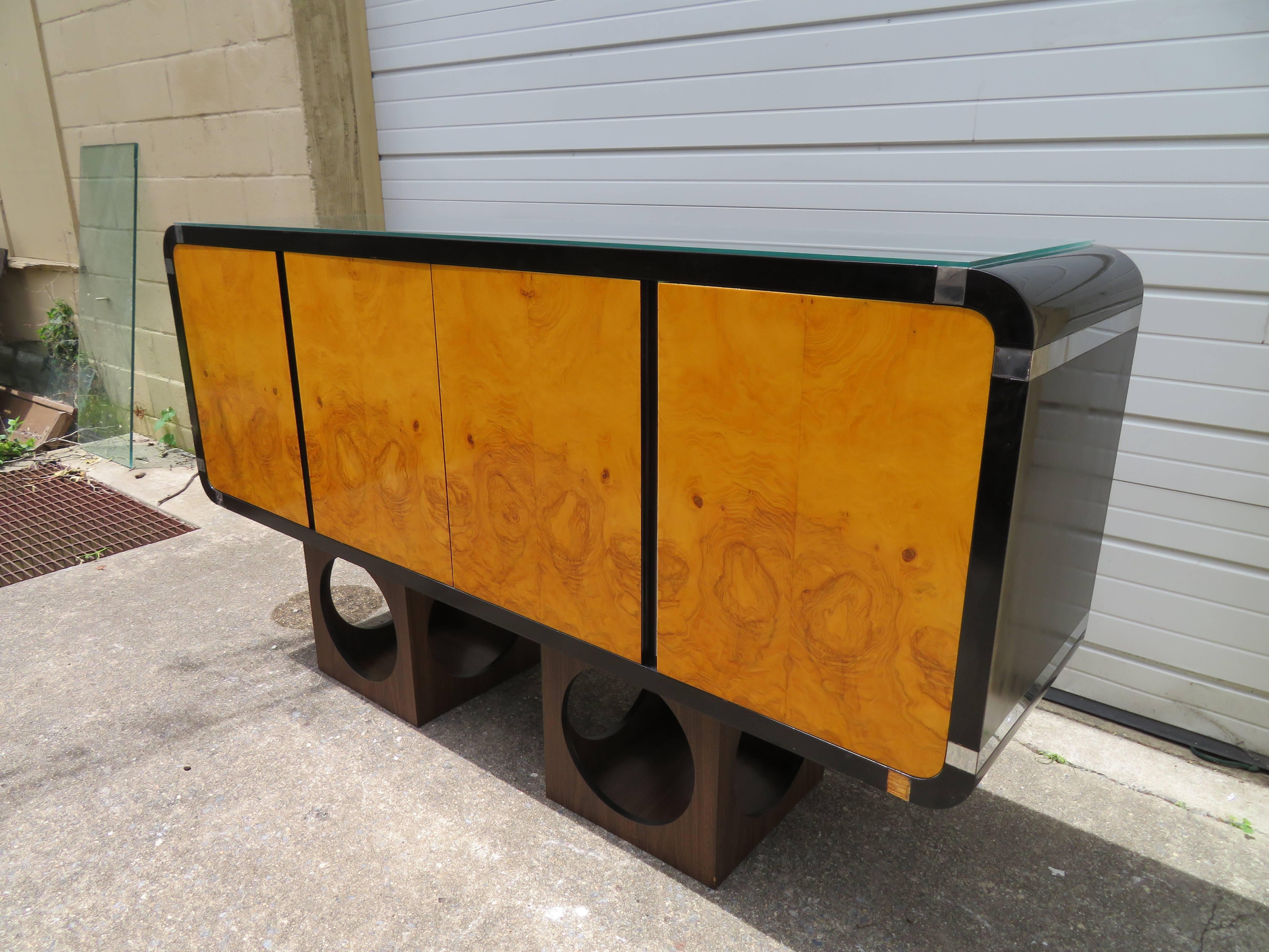 Handsome burled olivewood and ebonized lacquer floating credenza. There is a nice custom glass piece on the top and a beveled recessed hanging bar on the back to make installing easy. This piece retains it's original black lacquer in nice vintage