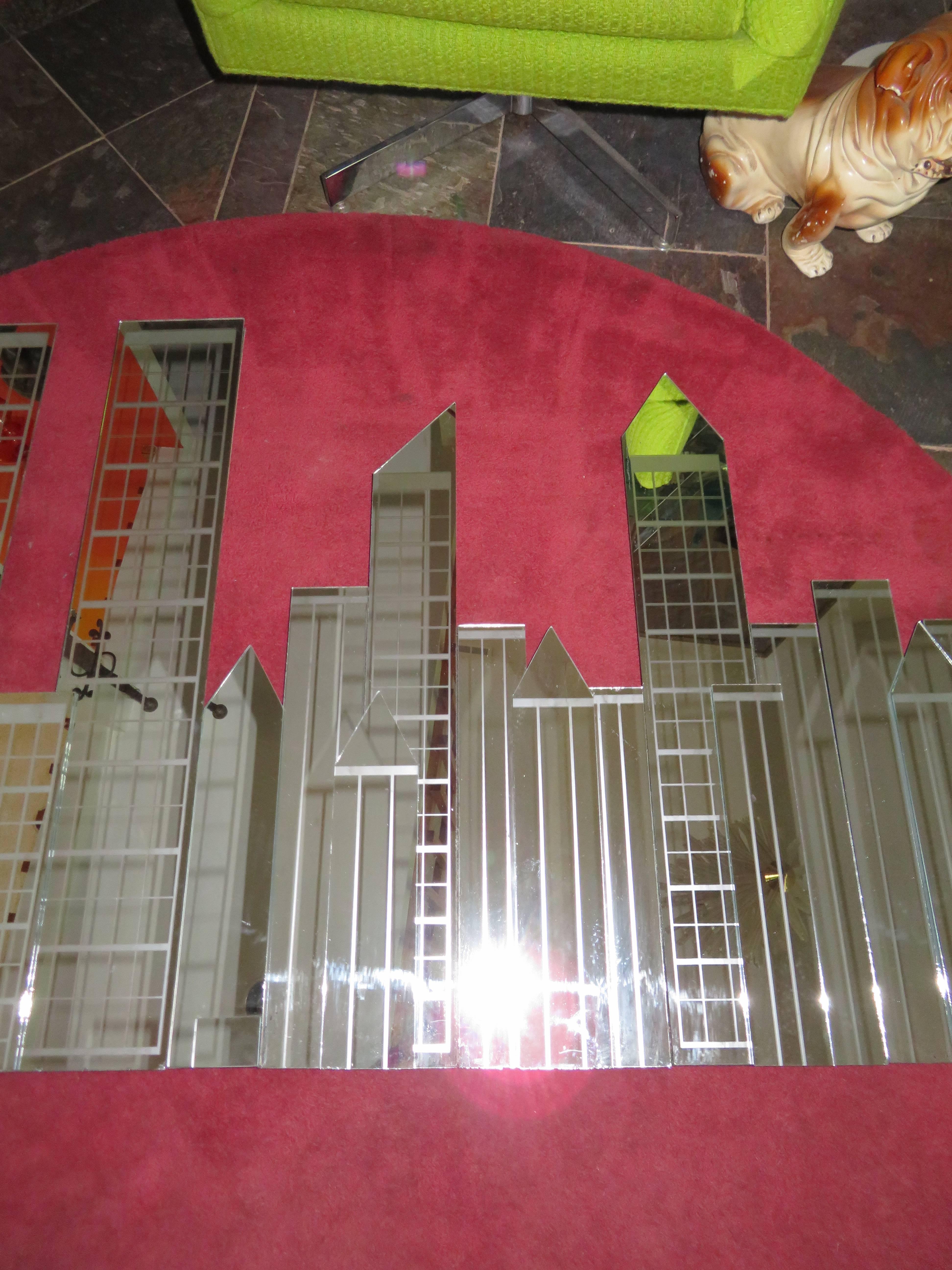 Fabulous four-piece NYC skyline mirror wall sculpture made by Mechanical Mirror Works. Really cool mirror sculpture of the NYC skyline pre 911 with Twin Towers. This mirror sculpture comes in four sections with hangers on the back of each section.