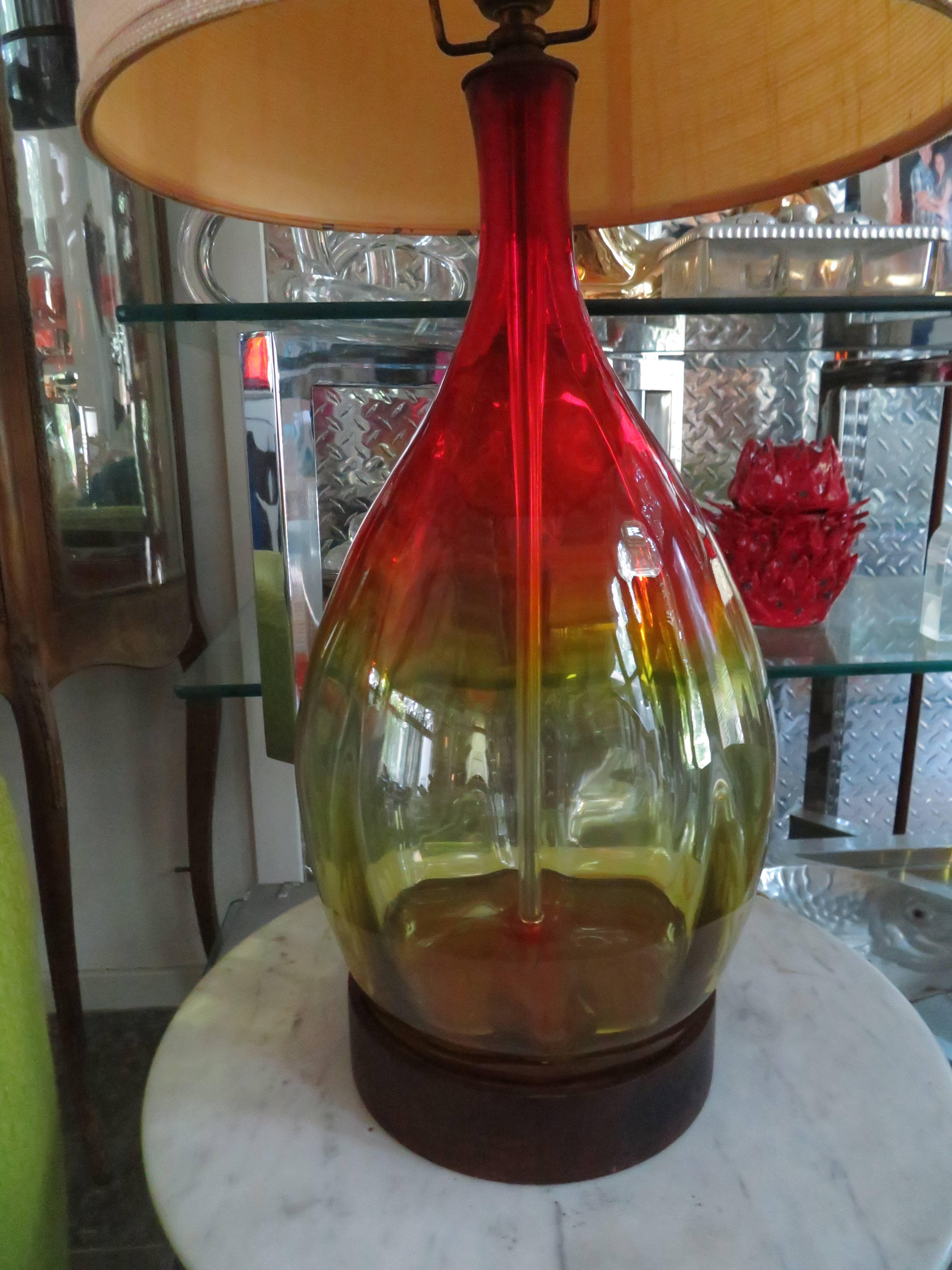 Stunning vintage amberina red and orange Blenko lamp with original finial. The original lampshade show some light wear but the vintage Blenko Glass is in perfect condition. Lamp retains it's original wiring in working order.