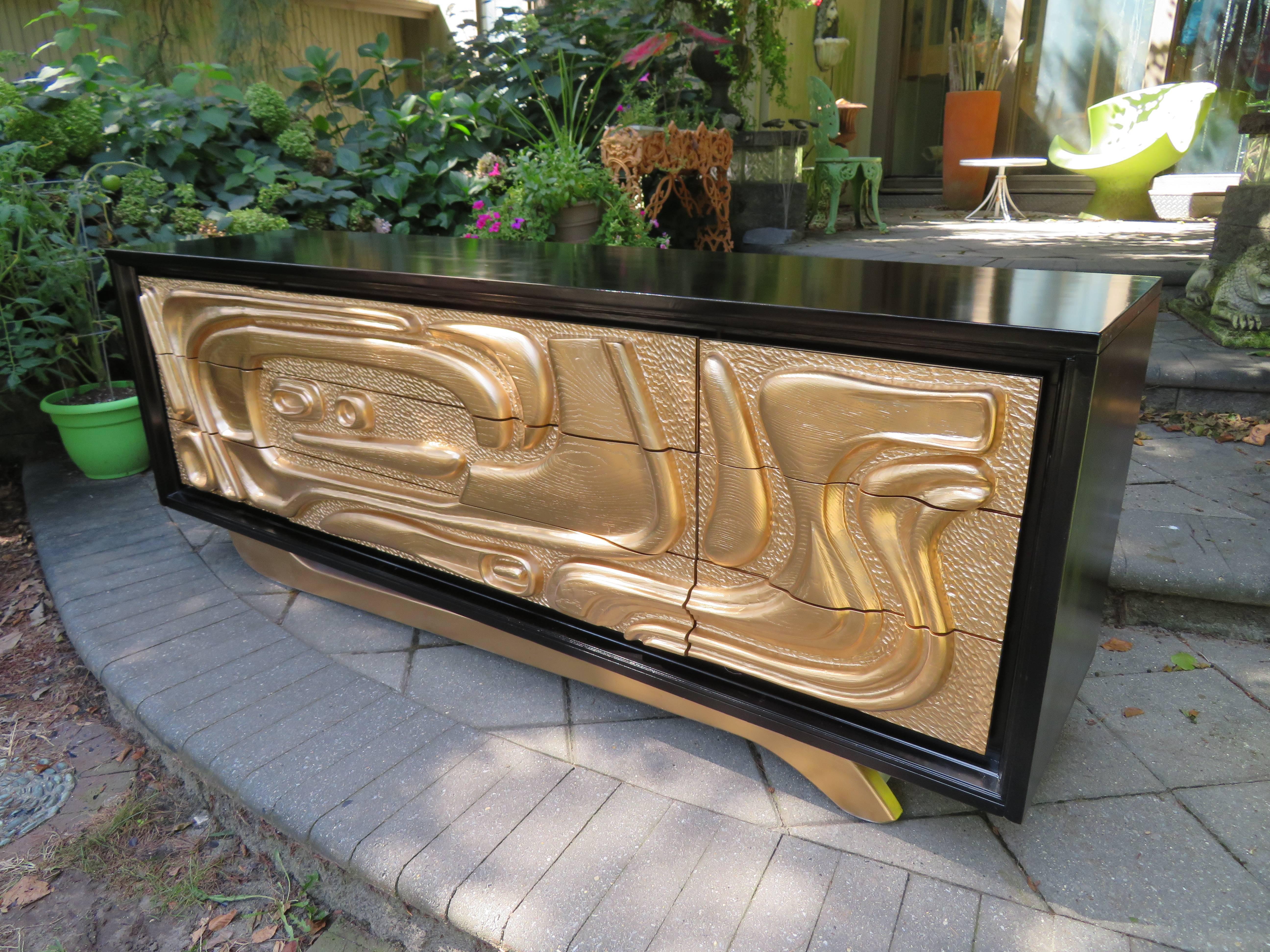 Fabulous Witco style oceanic nine-drawer dresser with newly refinished gilded gold fronts and satin black cabinet. This design is by Pulaski Furniture Corporation. This is the exact same designed cabinet that was in Don Draper's office in Mad Men