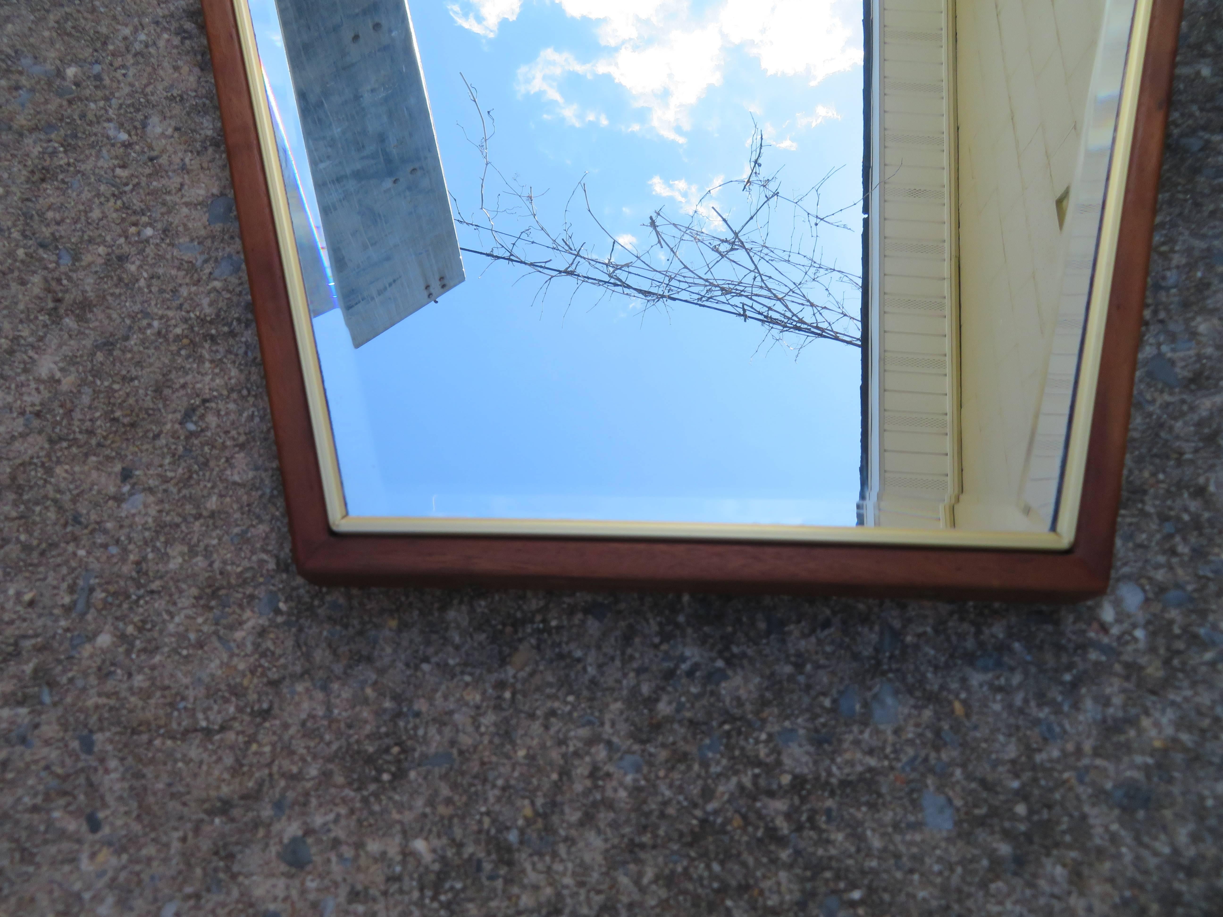 Lovely Mid-Century Modern diamond shaped walnut framed mirror. Well crafted and stylish this mirror is just fabulous in person. It measures 49.5