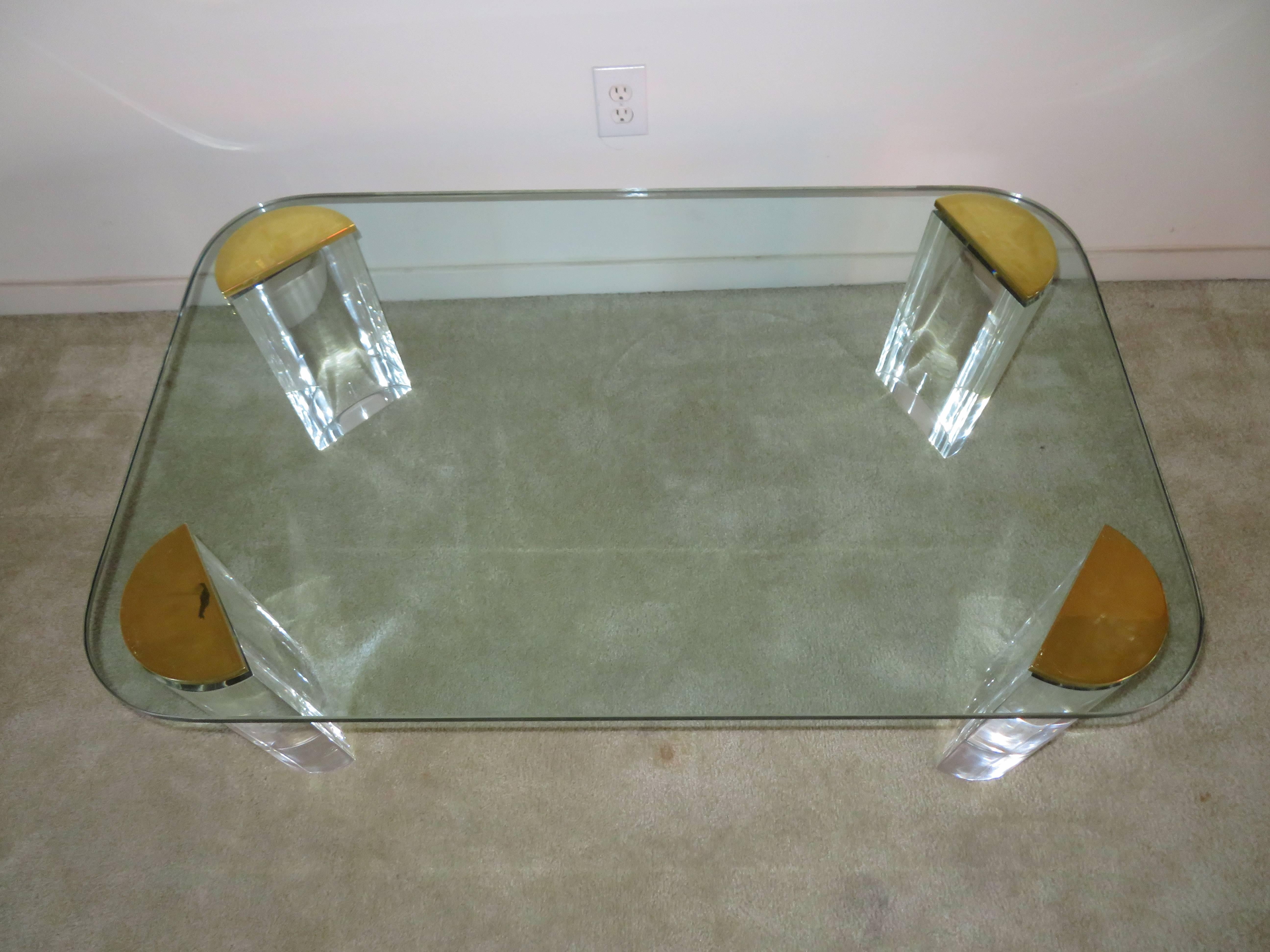 Midcentury chunky Lucite and brass coffee table. This unusual table is in very nice vintage condition and makes a stunning statement-like a piece of jewelry.