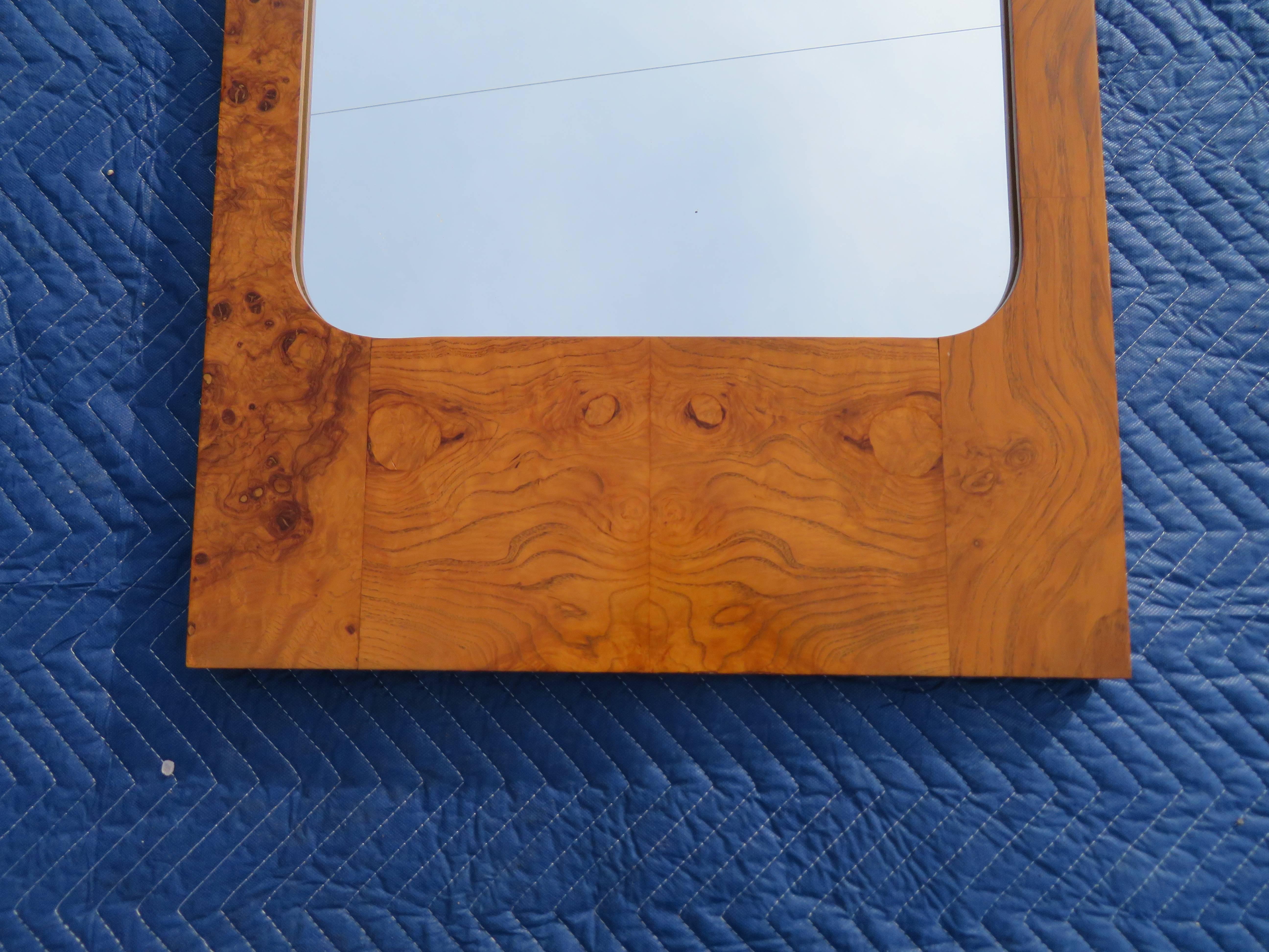 This gorgeous vintage modern mirror features a lovely burl olive wood frame. Sleek rectangular design with elegant wood grain throughout makes this wonderful mirror the perfect addition to any modern interior. 
